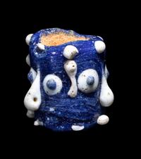 A Phoenician Glass Triple-Face Bead