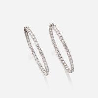 A pair of diamond and fourteen karat white gold earrings