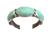 A Navajo Silver and Turquoise Bracelet Length 5 7/8 x opening 1 1/8 x width 1 1/4 inches. — CIRCA 1920