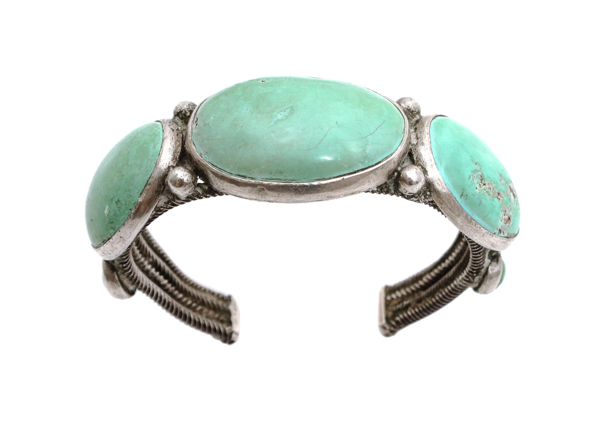 A Navajo Silver and Turquoise Bracelet Length 5 7/8 x opening 1 1/8 x width 1 1/4 inches. — CIRCA 1920