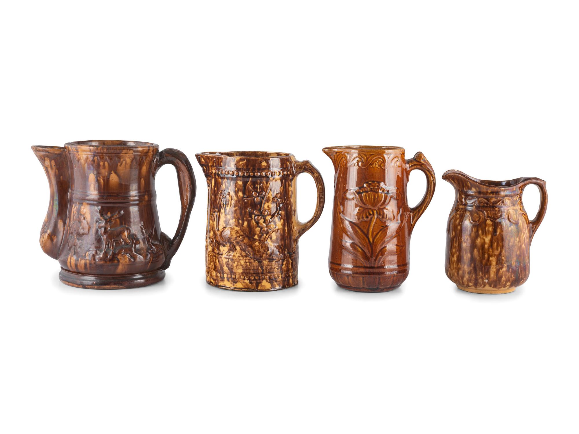 Seven Molded Yellowware Pitchers in Rockingham Glaze