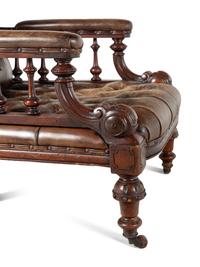 A Pair of English Carved Mahogany Buttoned Leather Armchairs