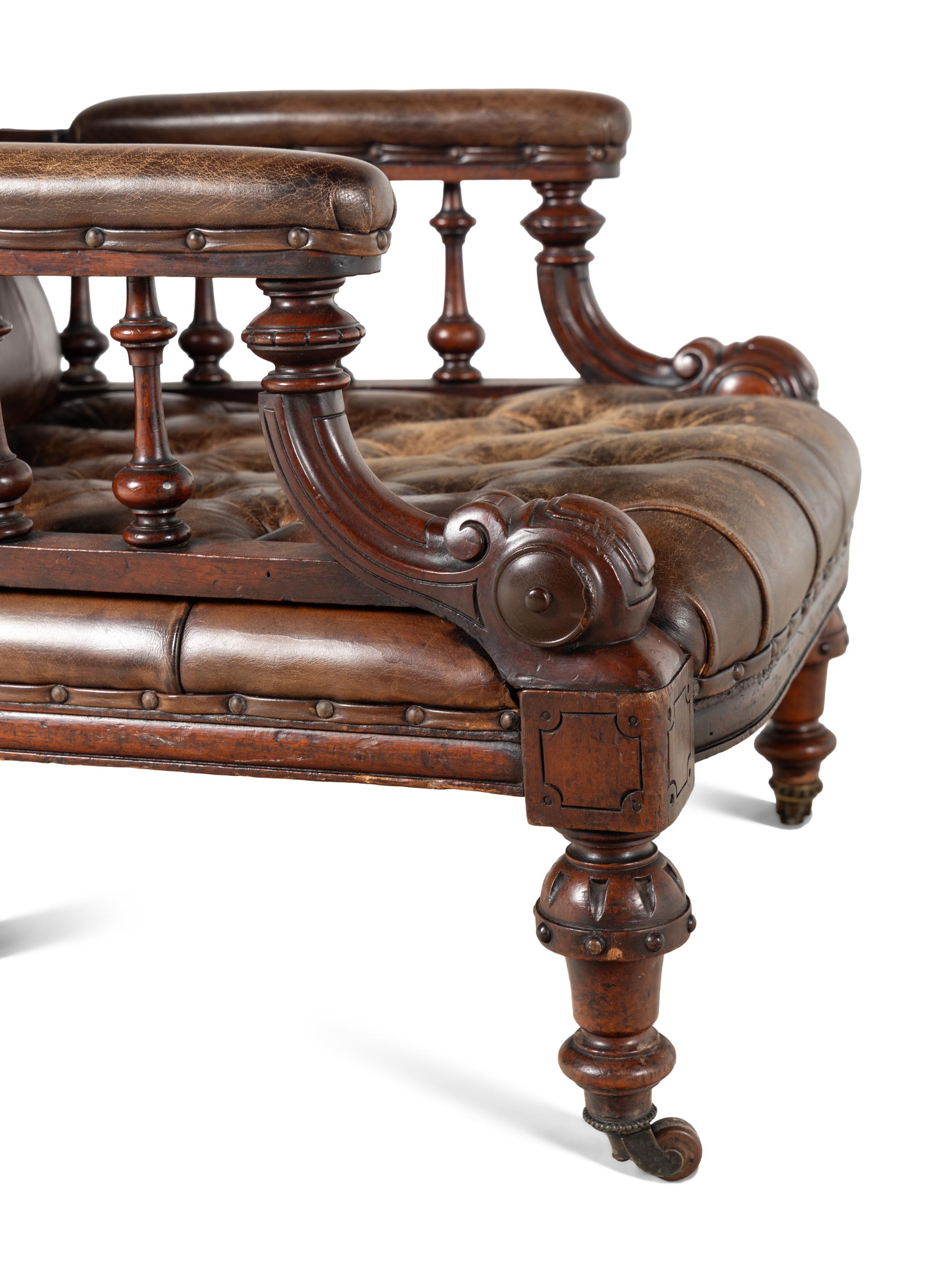A Pair of English Carved Mahogany Buttoned Leather Armchairs