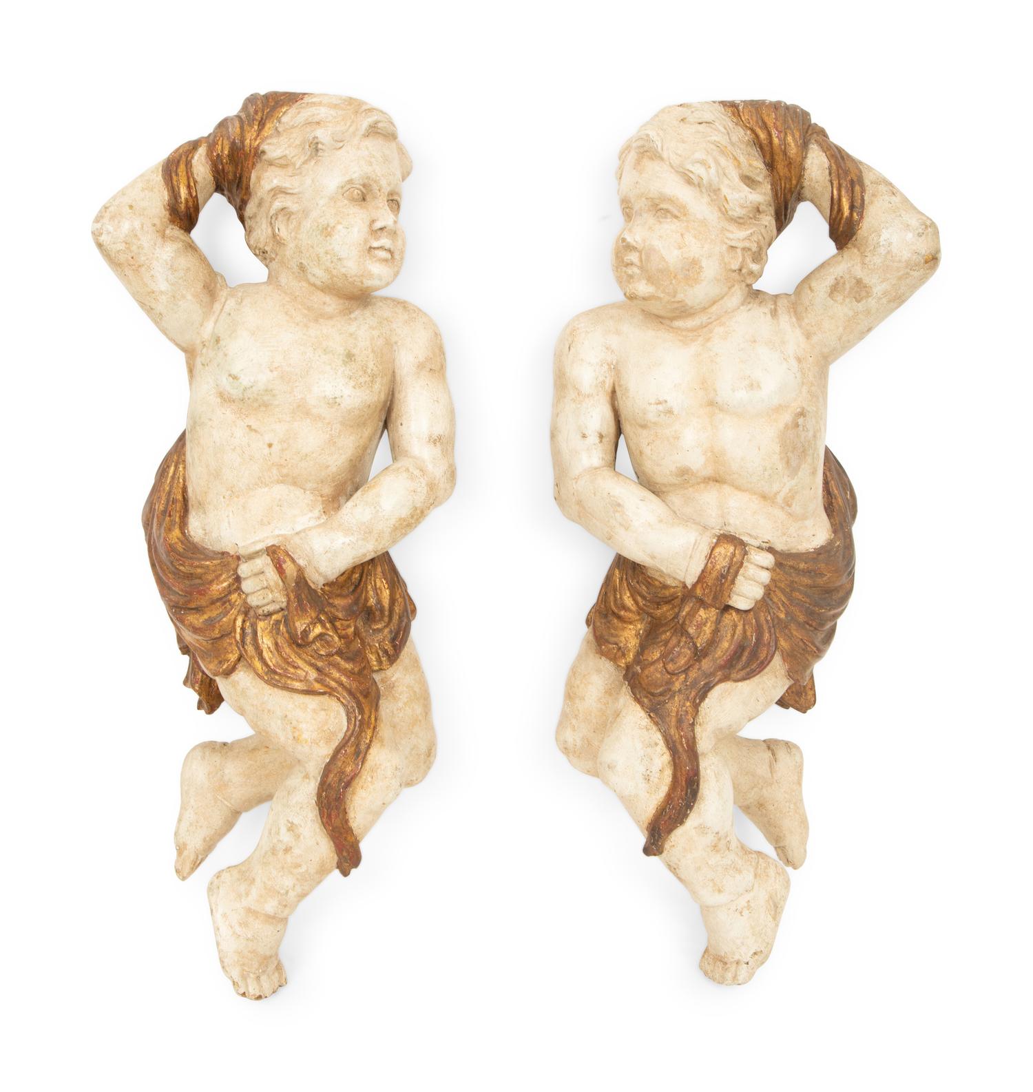 A Pair of Italian Carved, Painted and Parcel Gilt Putti