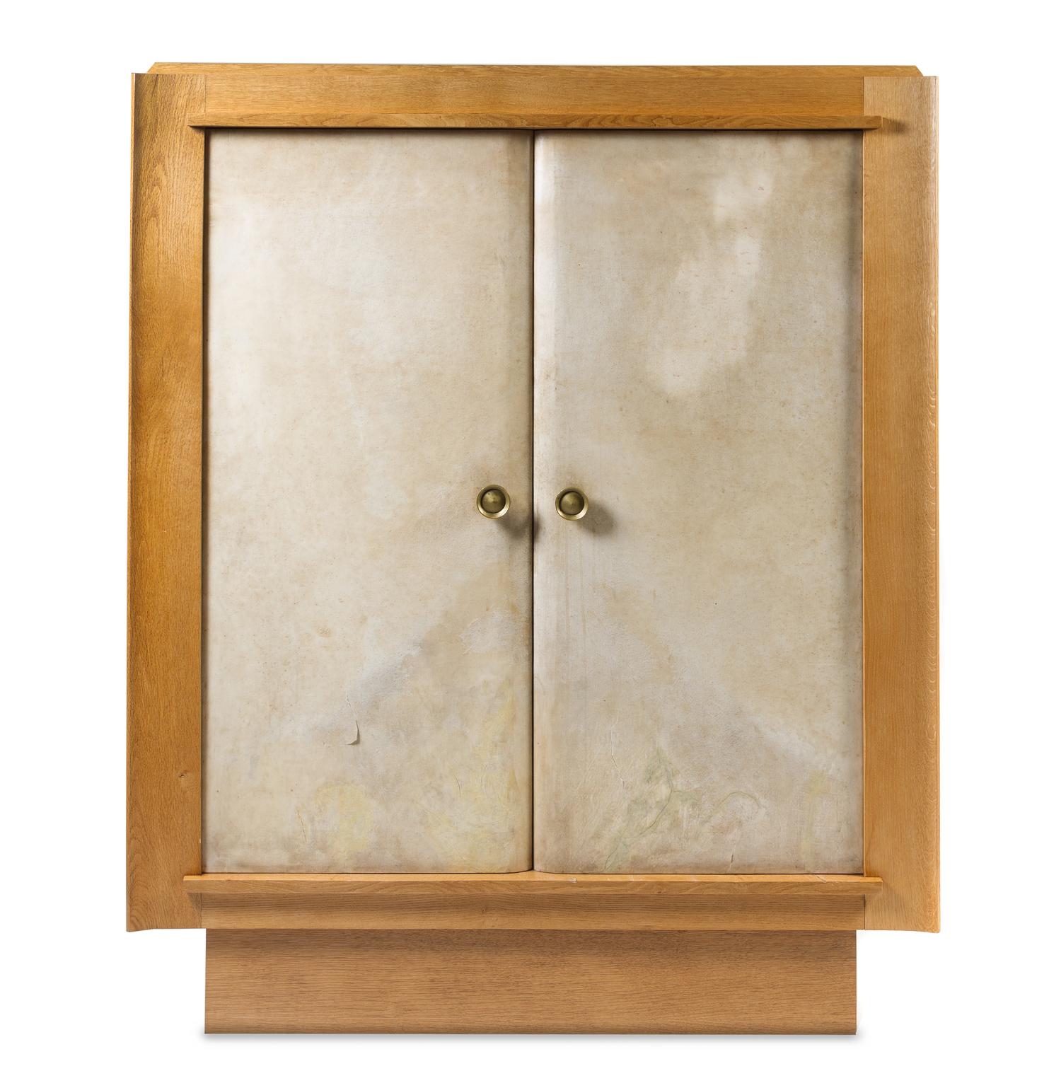 An Oak and Vellum Wardrobe Height 67 3/8 x width 54 3/4 x depth 19 7/8 inches.