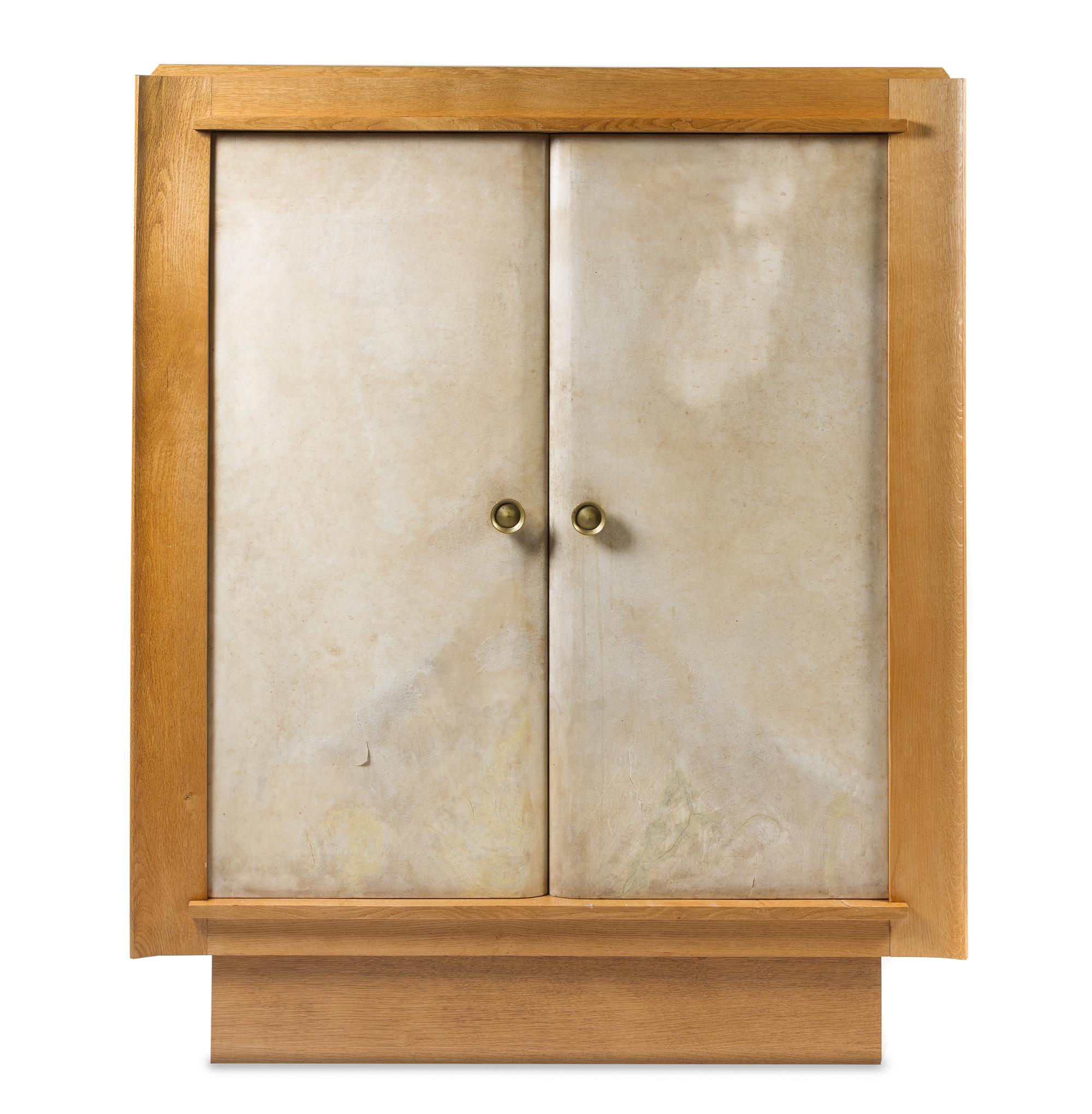 An Oak and Vellum Wardrobe Height 67 3/8 x width 54 3/4 x depth 19 7/8 inches.