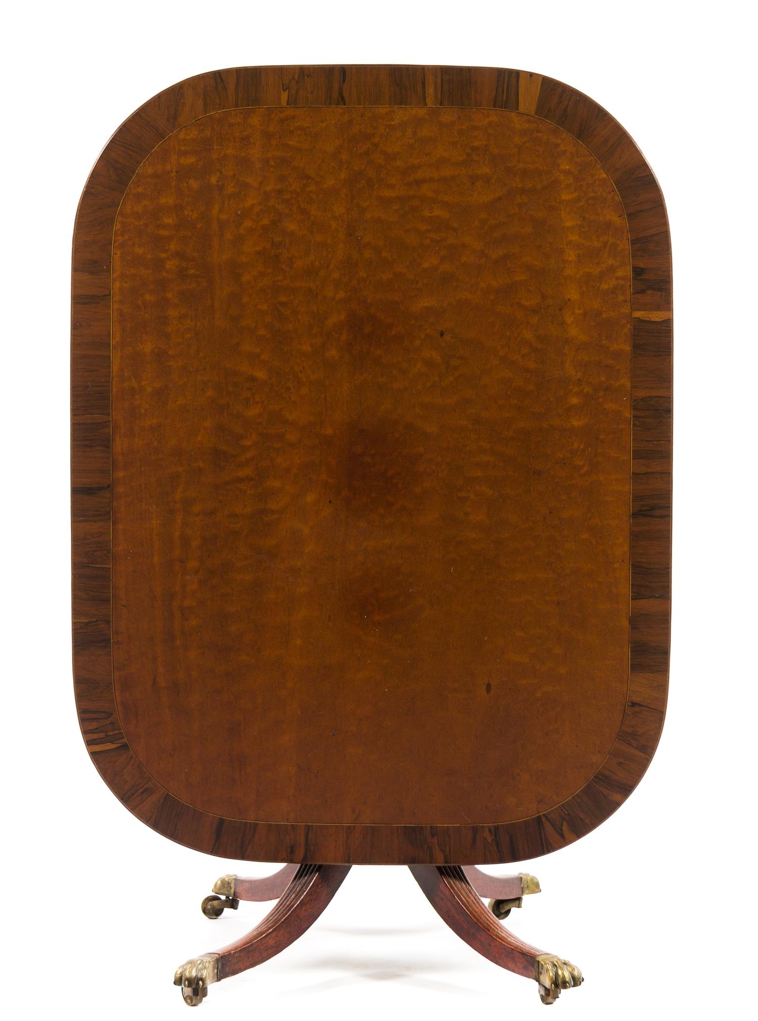 A Regency Rosewood Banded Mahogany Breakfast Table Height 27 1/2 x width 49 1/2 x depth 37 1/2 inches. — EARLY 19TH CENTURY