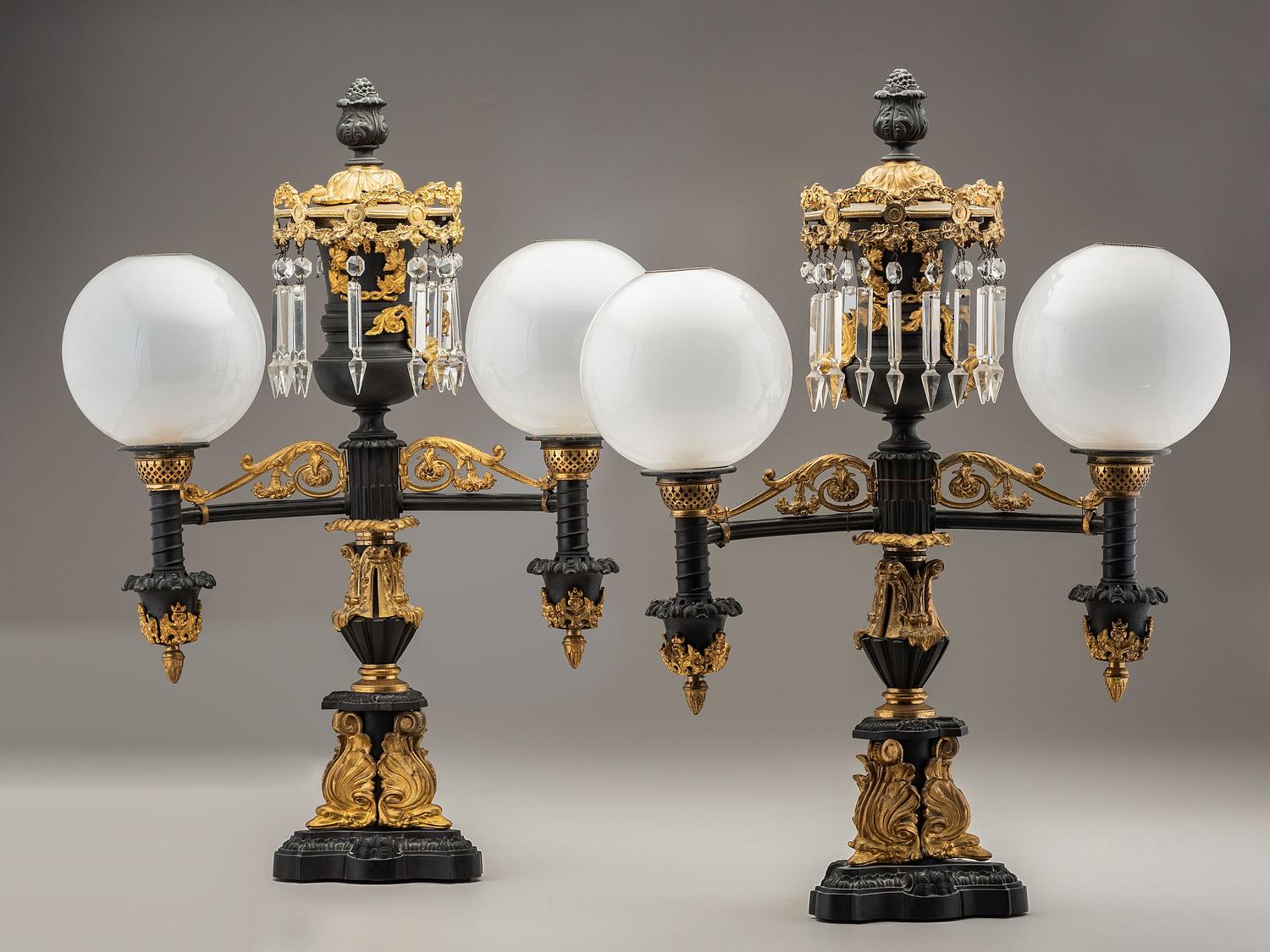 A Pair of Classical Gilt and Patinated Bronze Two-Light Argand Lamps with Shades