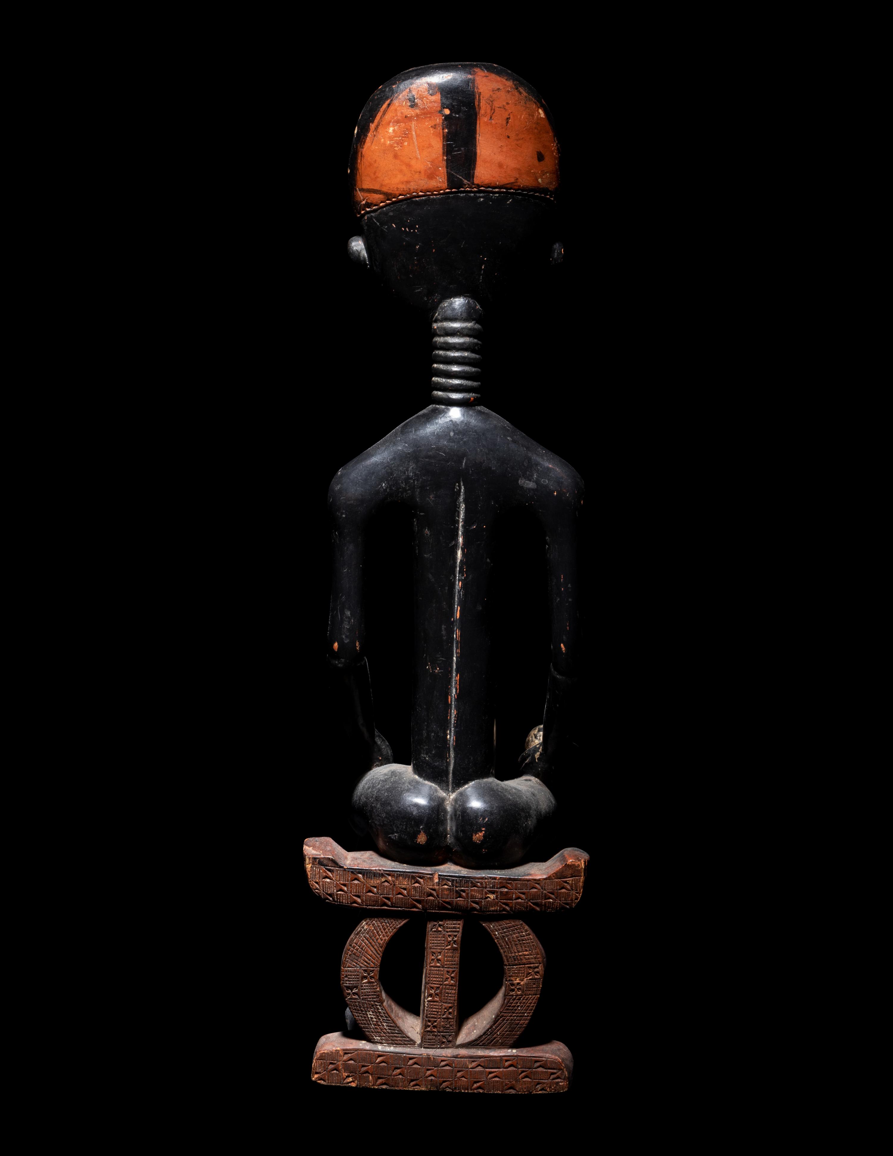 An Akan Wood Figure Seated on a Throne