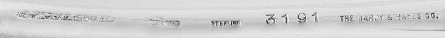 An American Silver Stuffing Spoon, Maker's Mark Obscured, having a zig-zag decorated border, retailed by The Hardy & Hayes Co., Pittsbu