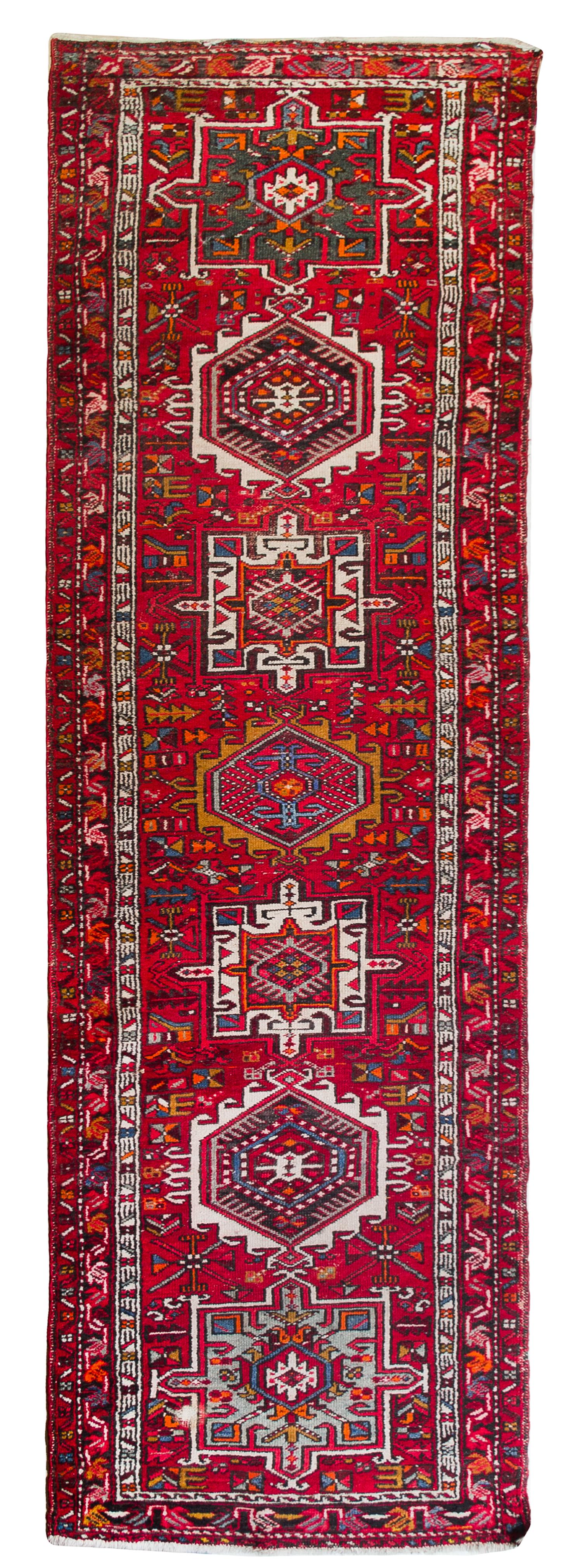 A Heriz Wool Runner 10 feet 8 1/2 inches x 2 feet 10 1/2 inches.