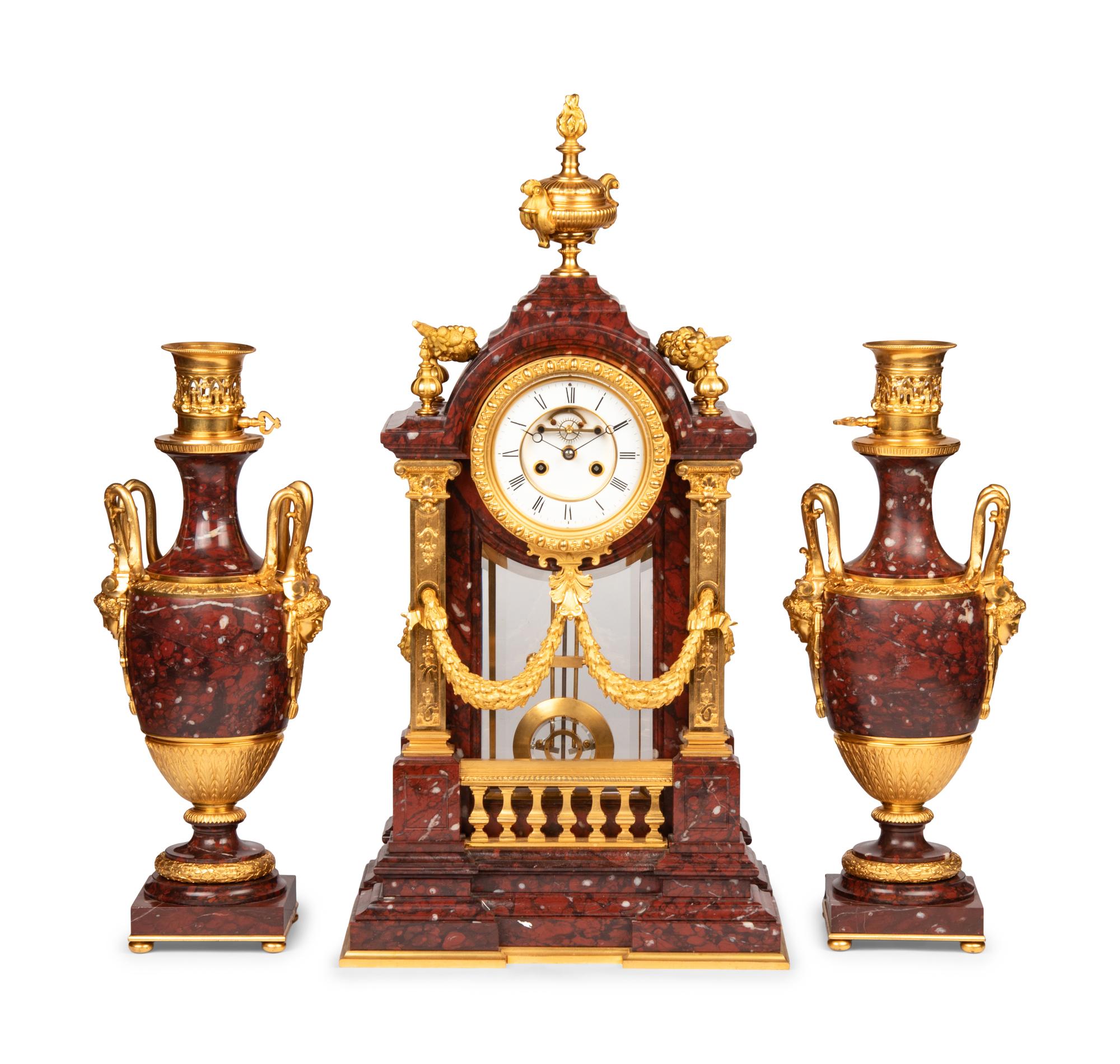 A Louis XVI Style Rouge Marble and Gilt Bronze Clock Garniture