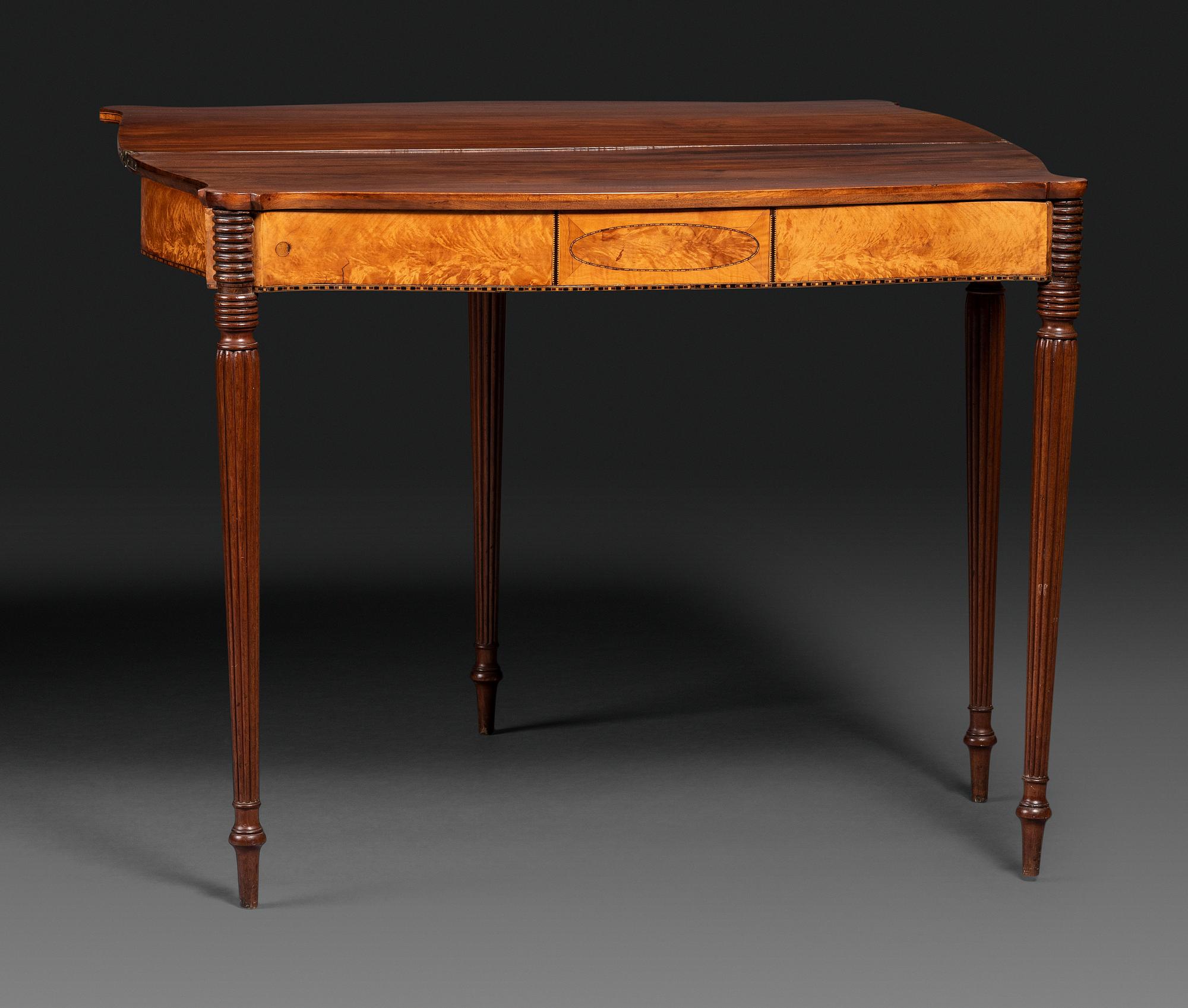 A Federal Birch Veneered and Inlaid Mahogany Serpentine-Top Games Table