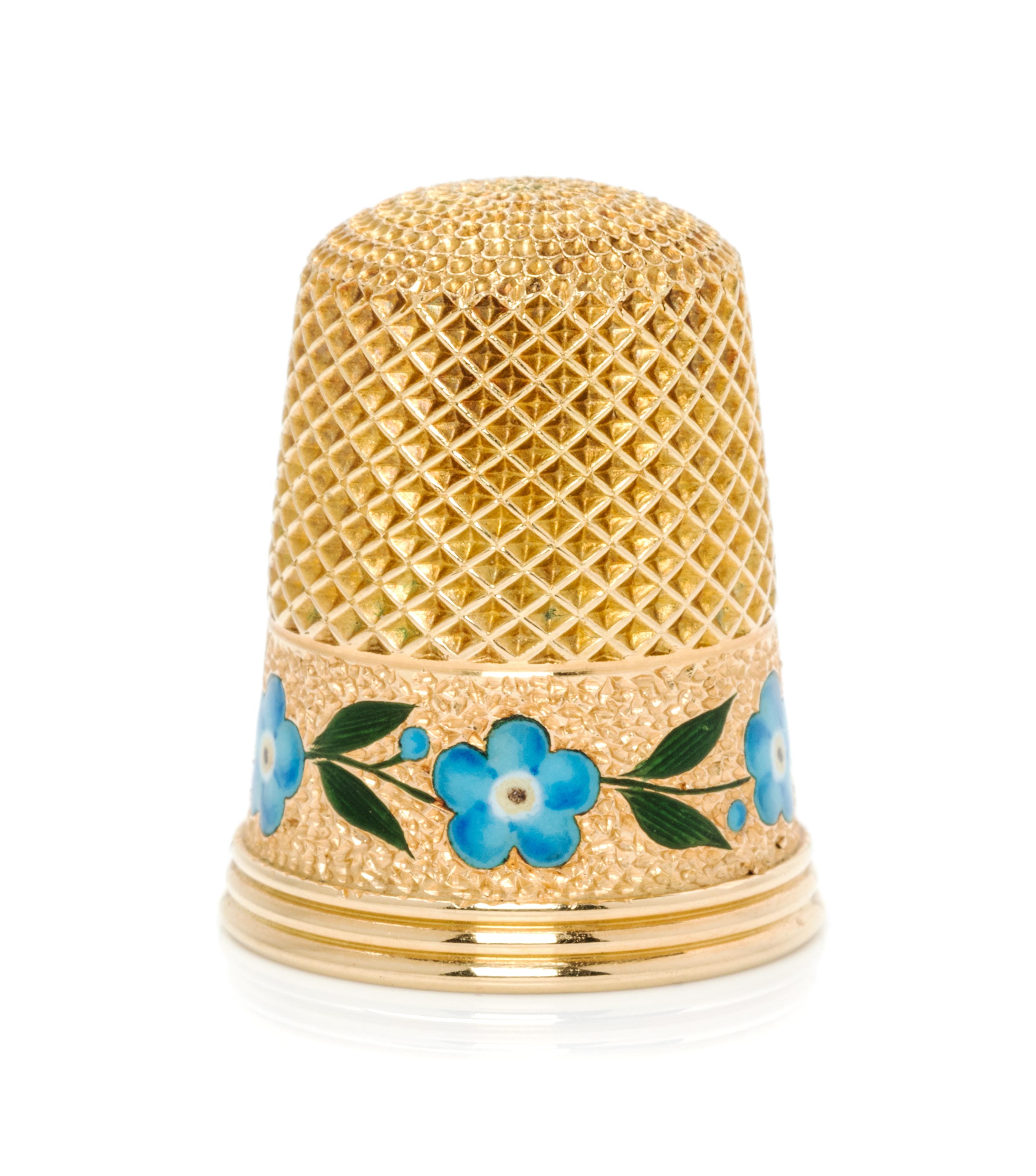 An American 18-Karat Yellow Gold and Enamel Thimble, Tiffany & Co., New York, NY, the knurled top and body above a polychrome enamel fl