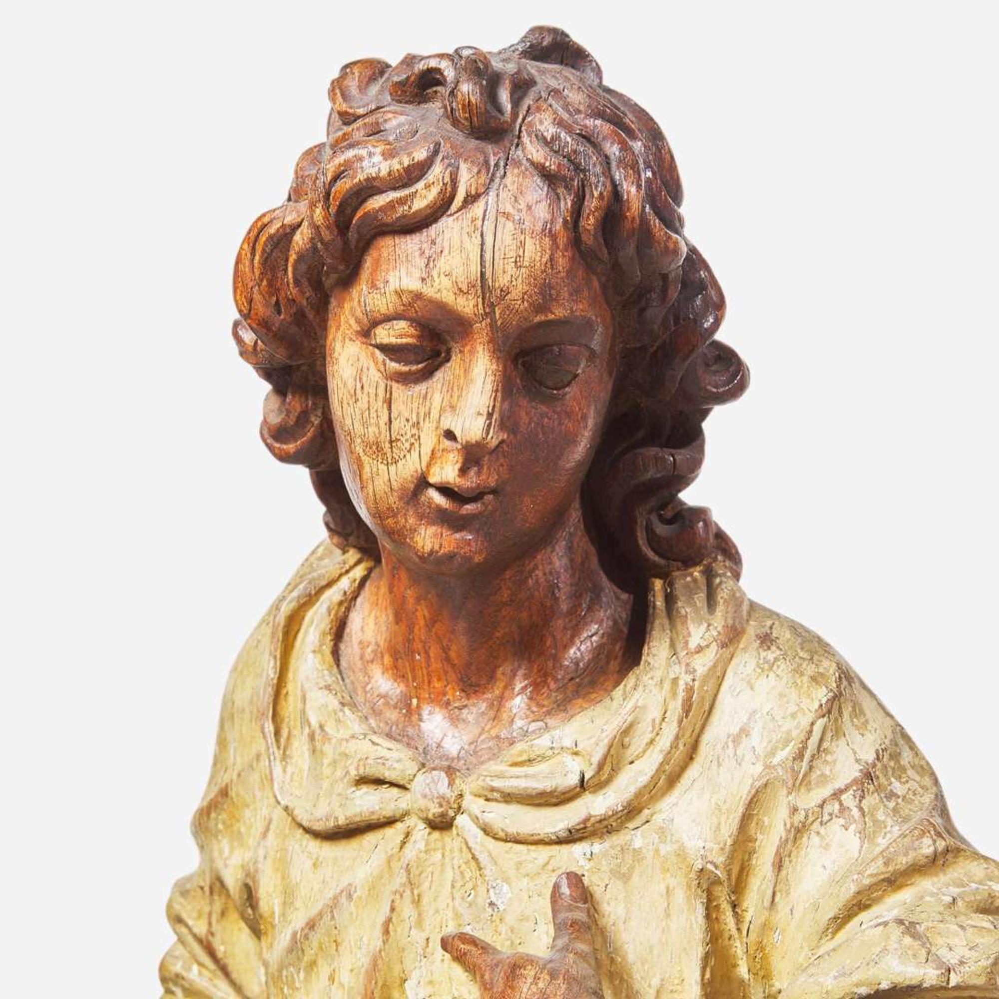 A pair of Italian carved and polychromed wood figures of young men 18th century