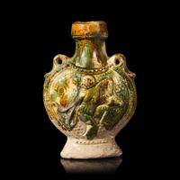 A Chinese Molded Sancai-Glazed Pottery Pilgrim Flask, Tang Dynasty 唐 三彩模印樂舞圖雙繫扁壺