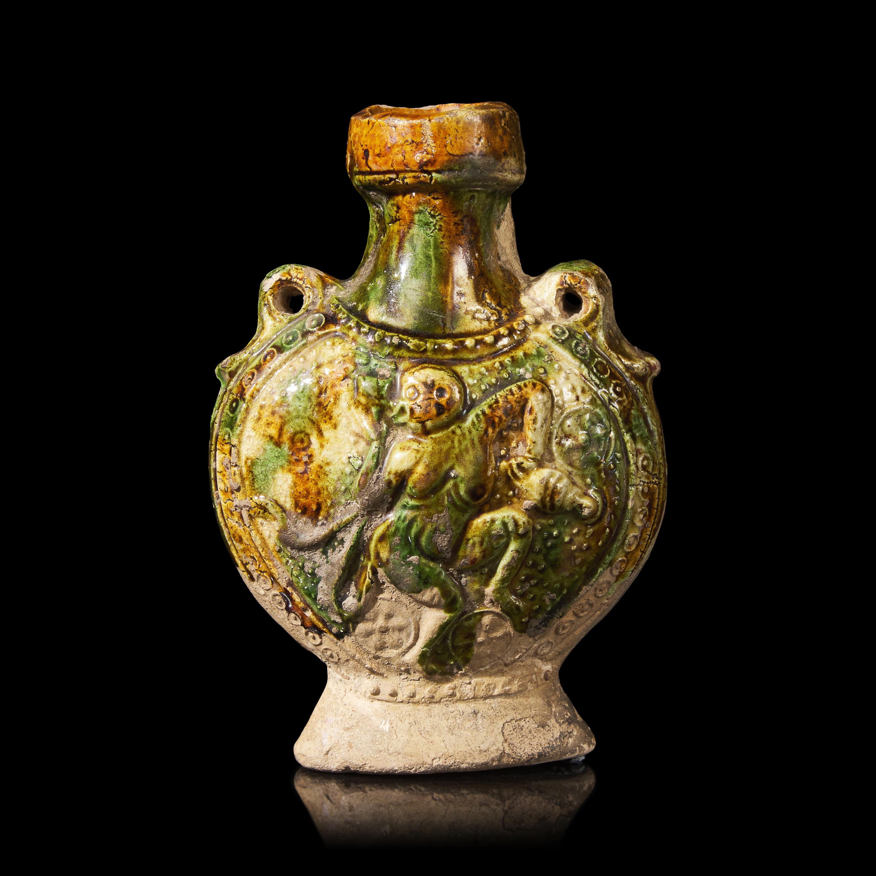 A Chinese Molded Sancai-Glazed Pottery Pilgrim Flask, Tang Dynasty 唐 三彩模印樂舞圖雙繫扁壺