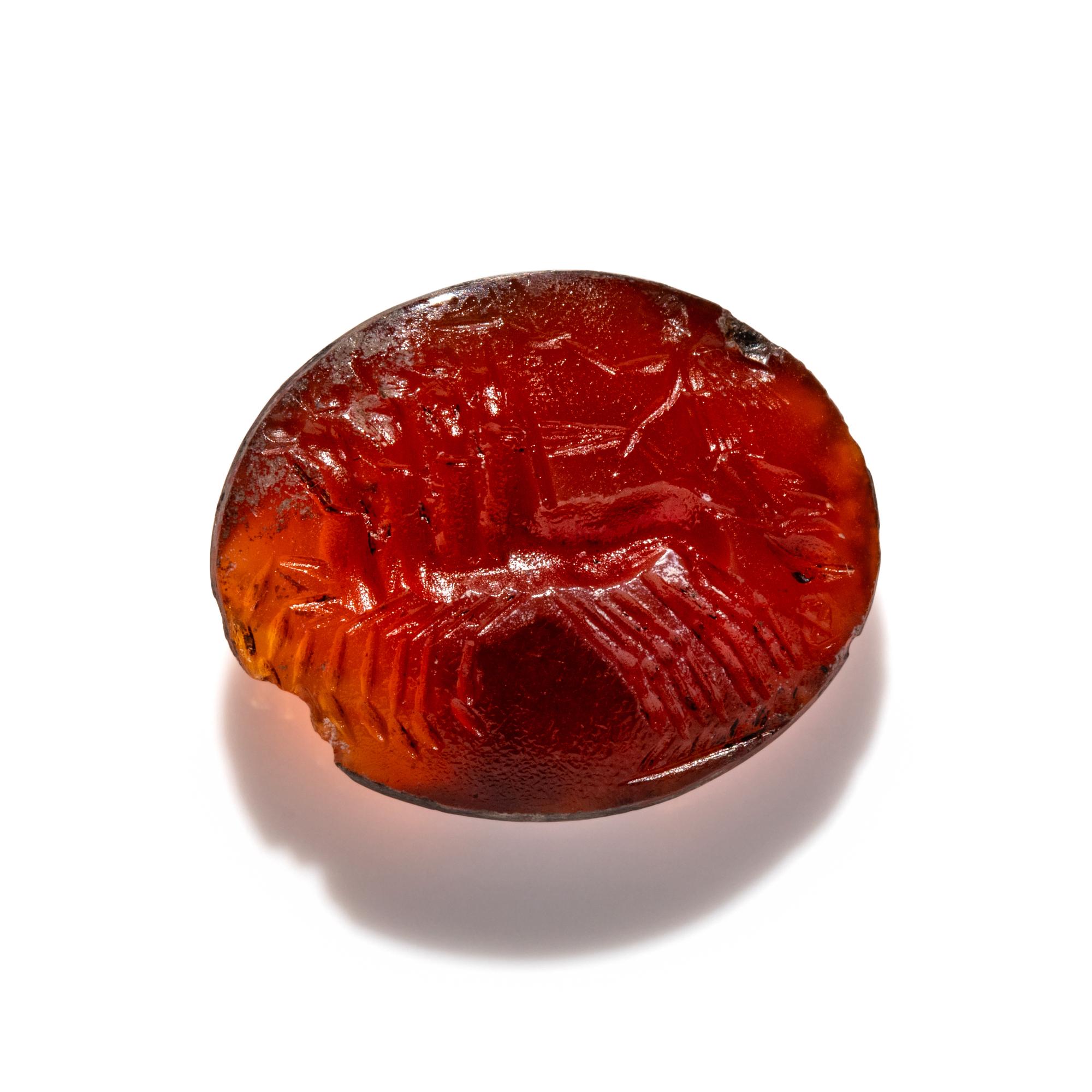 A Roman Carnelian Ring Stone with Nike Driving a Quadriga