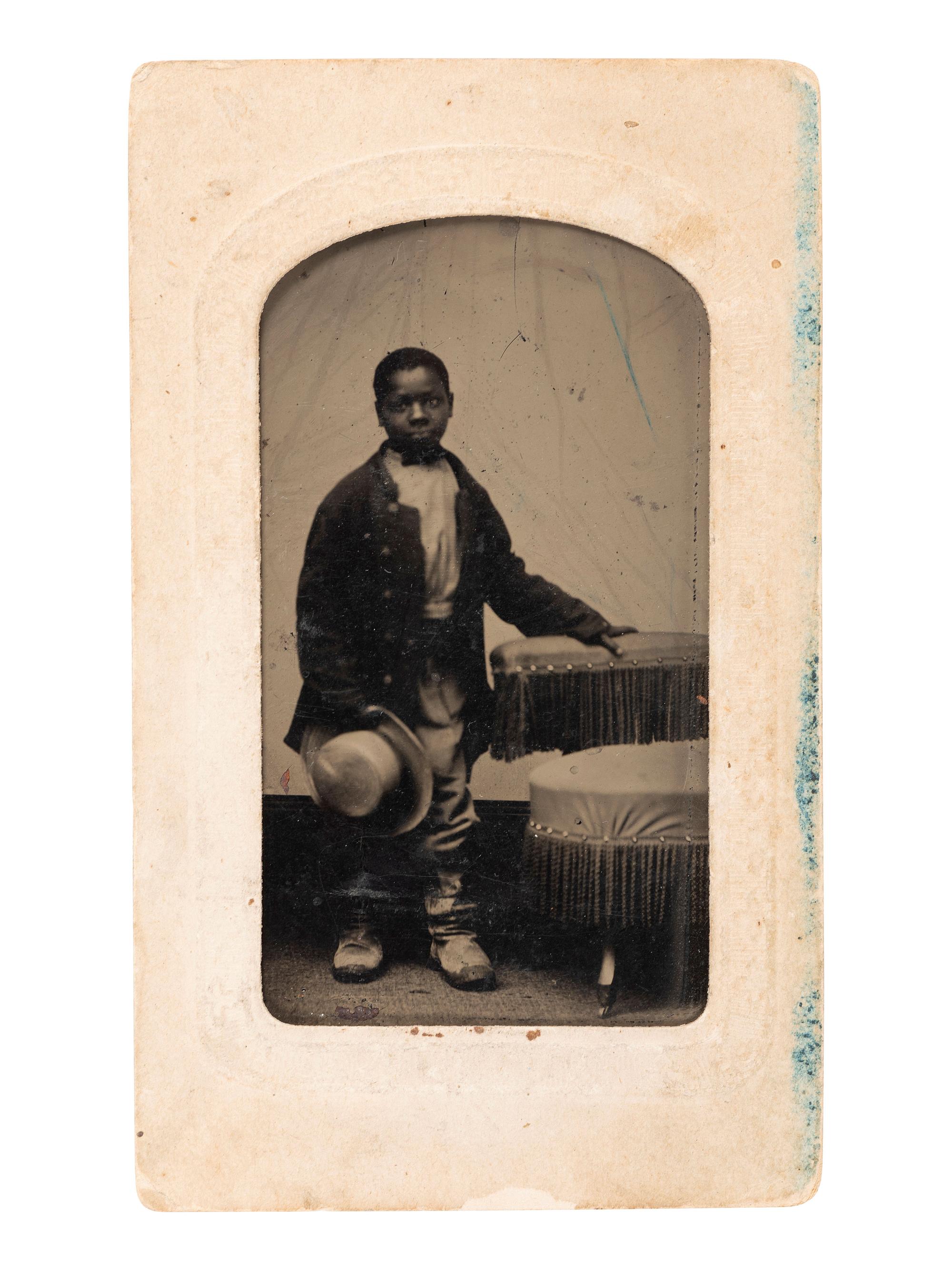 [AFRICAN AMERICANA - EARLY PHOTOGRAPHY]. Tintype of a young African American male subject in a military jacket.