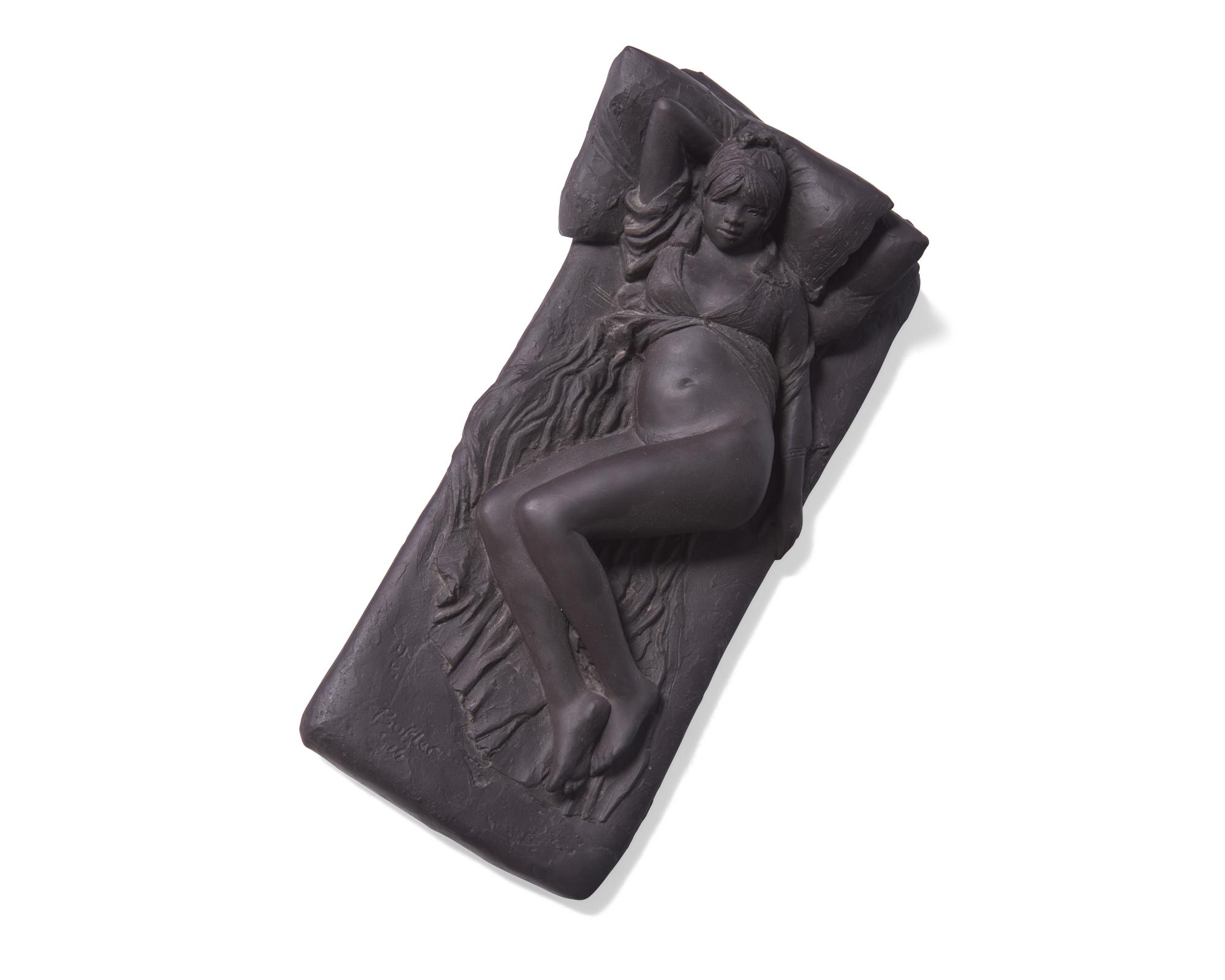 A Wedgwood Black Basalt "Girl on Bed" Figure