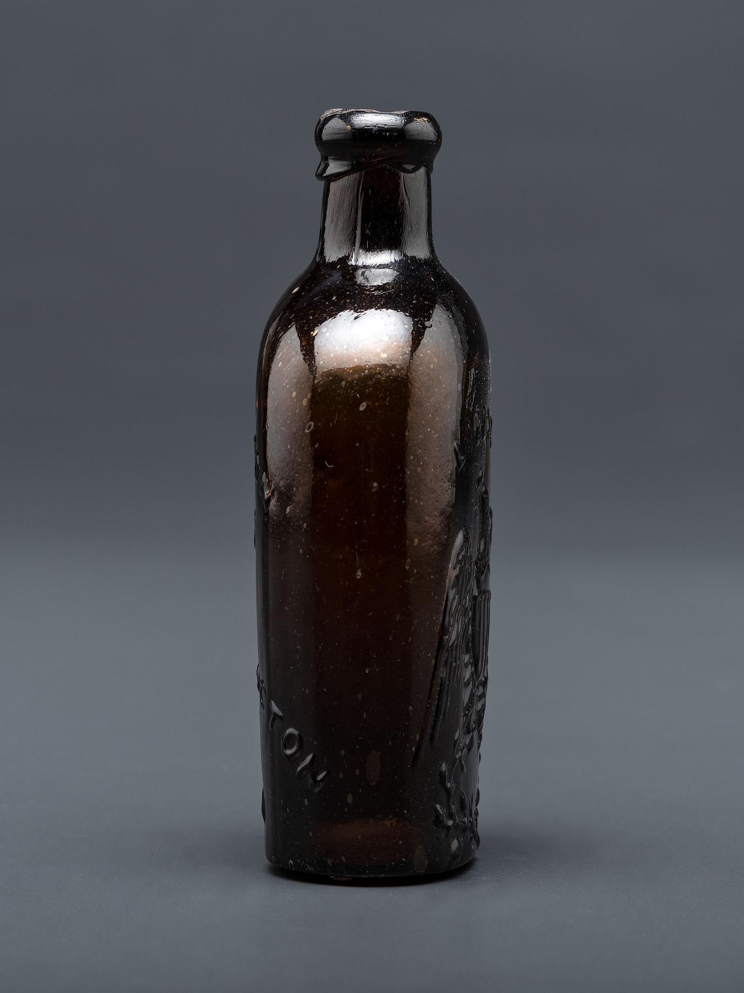 A Molded-Glass Flask in Amber by Willington Glass Company, Connecticut