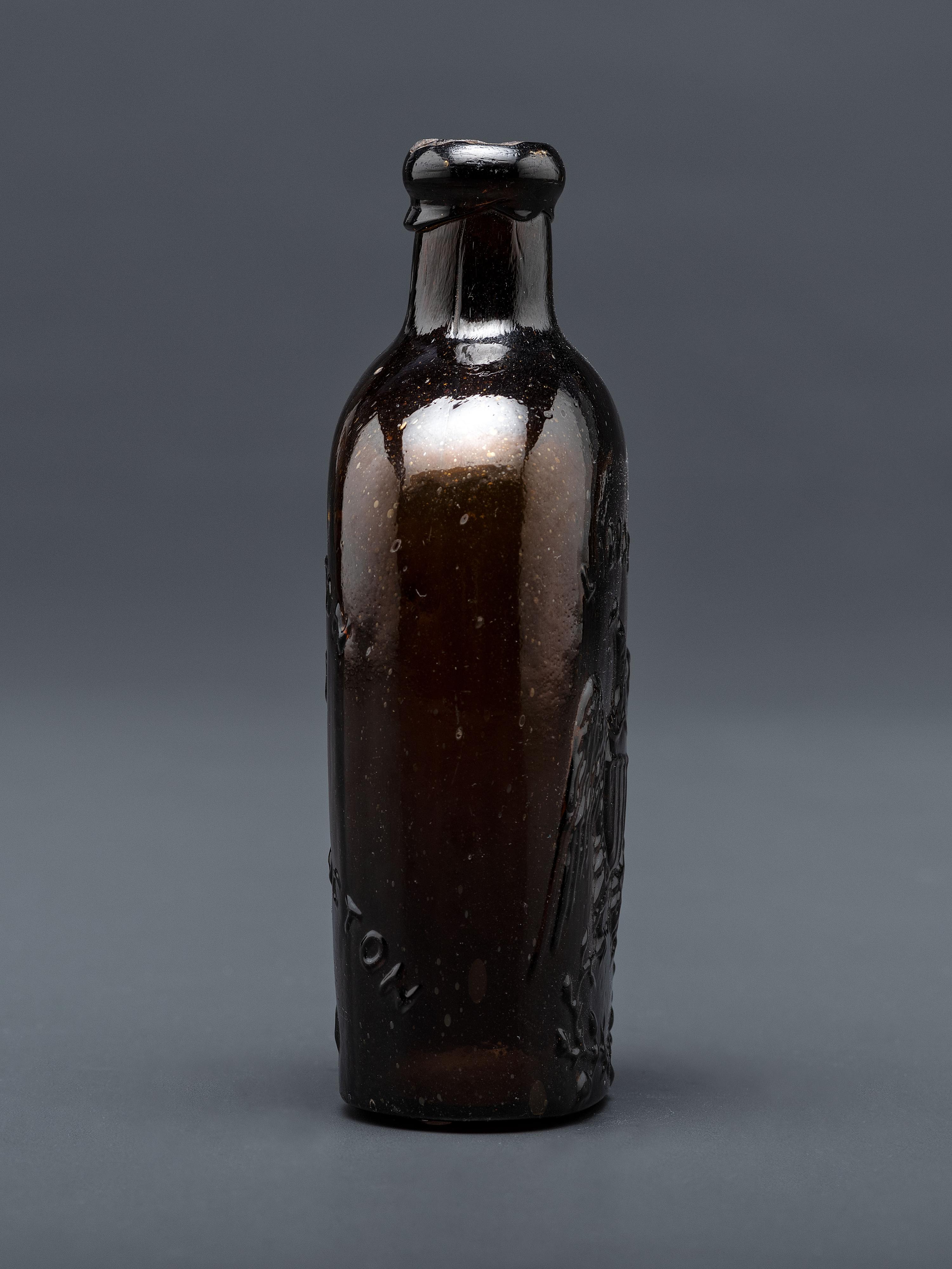 A Molded-Glass Flask in Amber by Willington Glass Company, Connecticut
