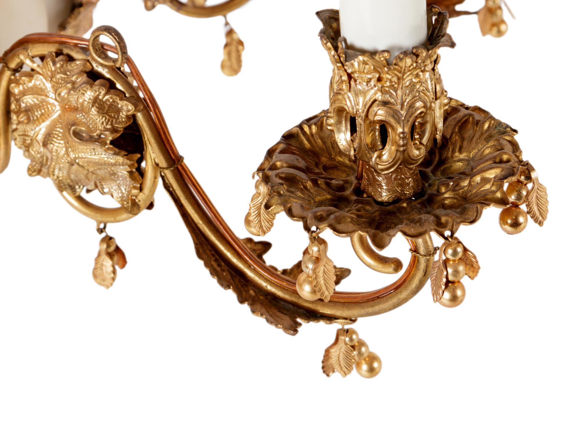 A Continental Gilt Metal and Jeweled Opaline Glass Twelve-Light Chandelier