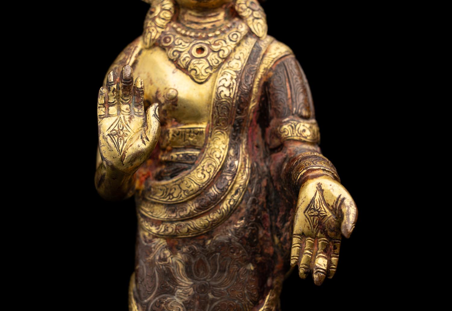 A Nepalese Gilt Bronze Standing Figure of Dipankara