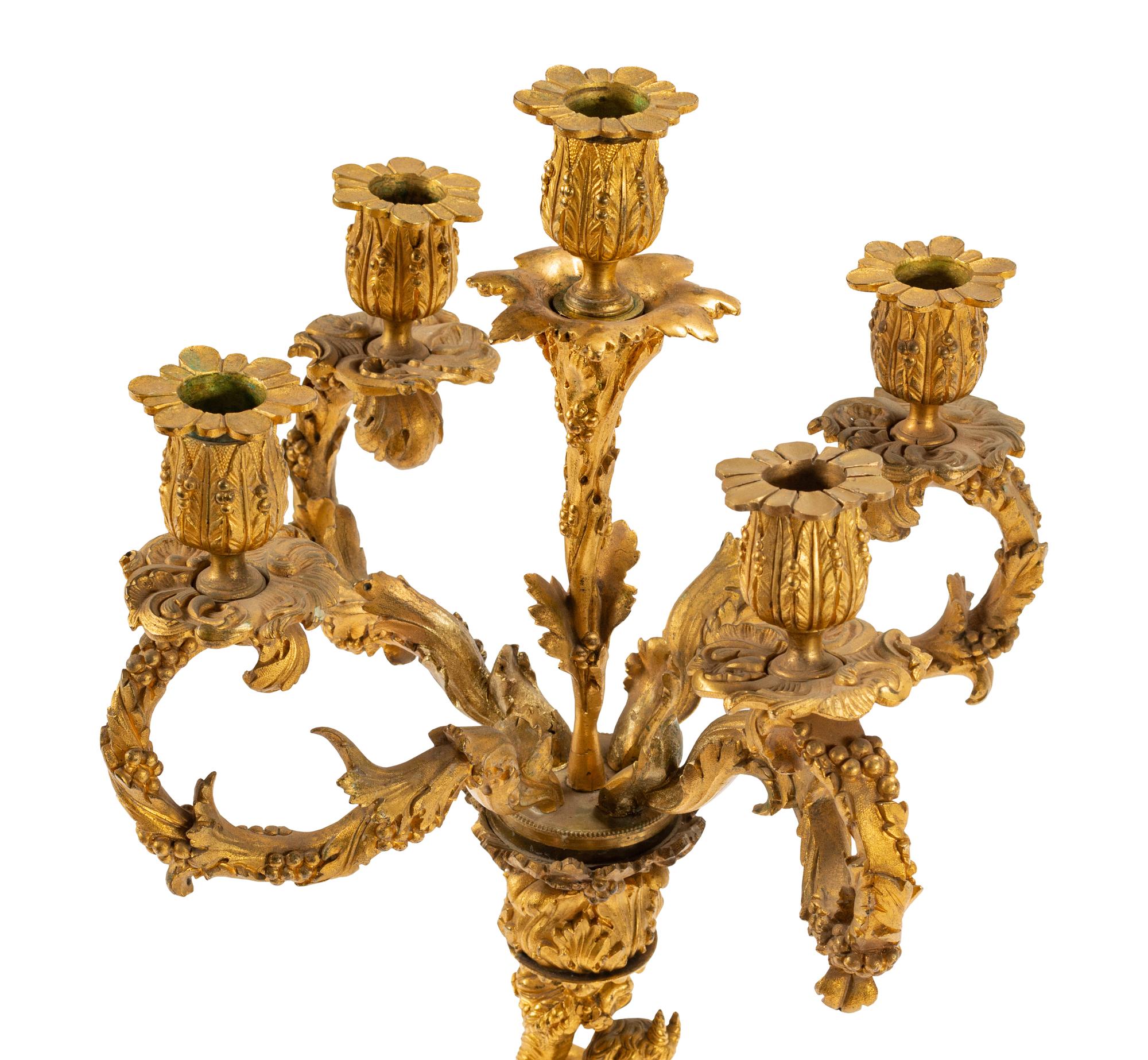 A Pair of Continental Gilt Bronze Figural Five-Light Candelabra with Malachite Veneered Bases