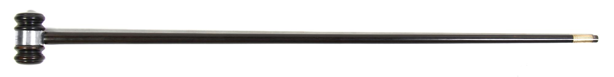 An Ebonized Presentation Cane, Height overall 36 1/2 x width of handle 3 1/8 inches.