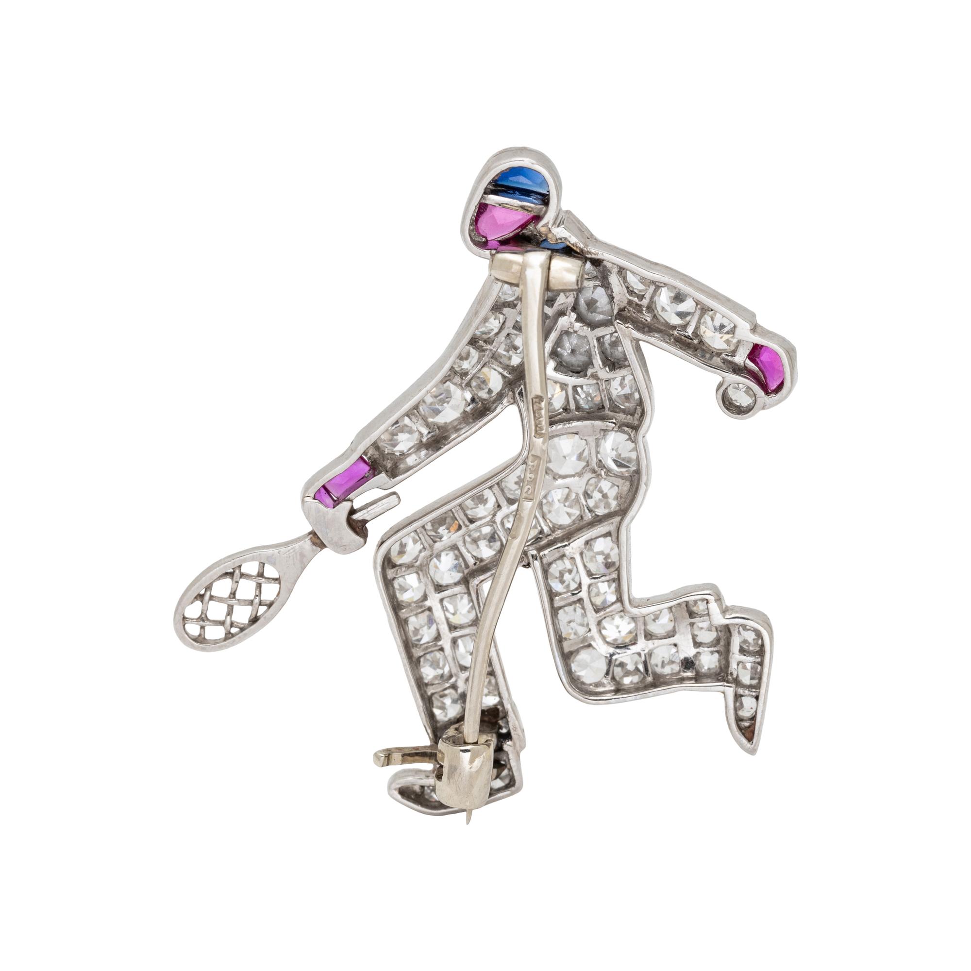 AUSTRIAN, ART DECO, DIAMOND, RUBY AND SAPPHIRE TENNIS PLAYER BROOCH