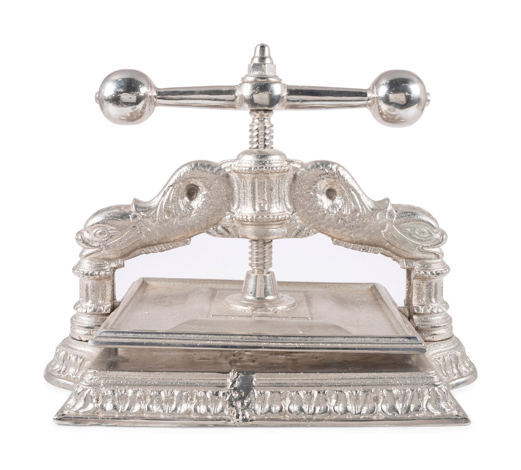 A Dolphin Form Silvered Metal Book Press