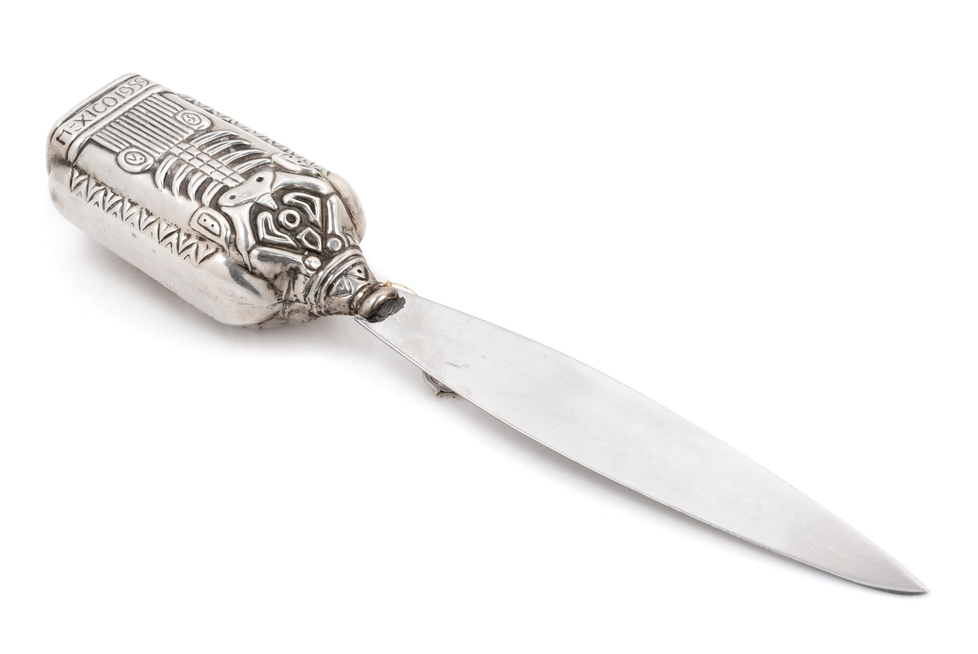 A Mexican Silver Paper Knife, Margot van Voorhies Carr, Taxco, Mid-20th Century, the handle worked with an Aztec deity, the reverse ins