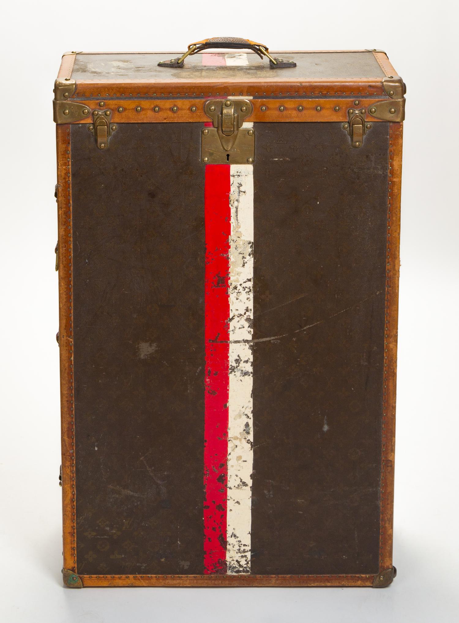 A Louis Vuitton Monogram Leather Wardrobe Trunk, 33.5"H x 21.25"W x 9"D.