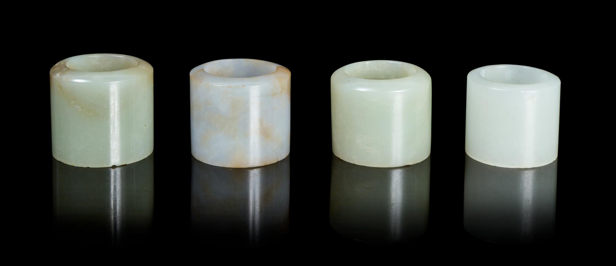 Four Jade Archer's Rings Diameter overall of largest 1 1/8 inches.