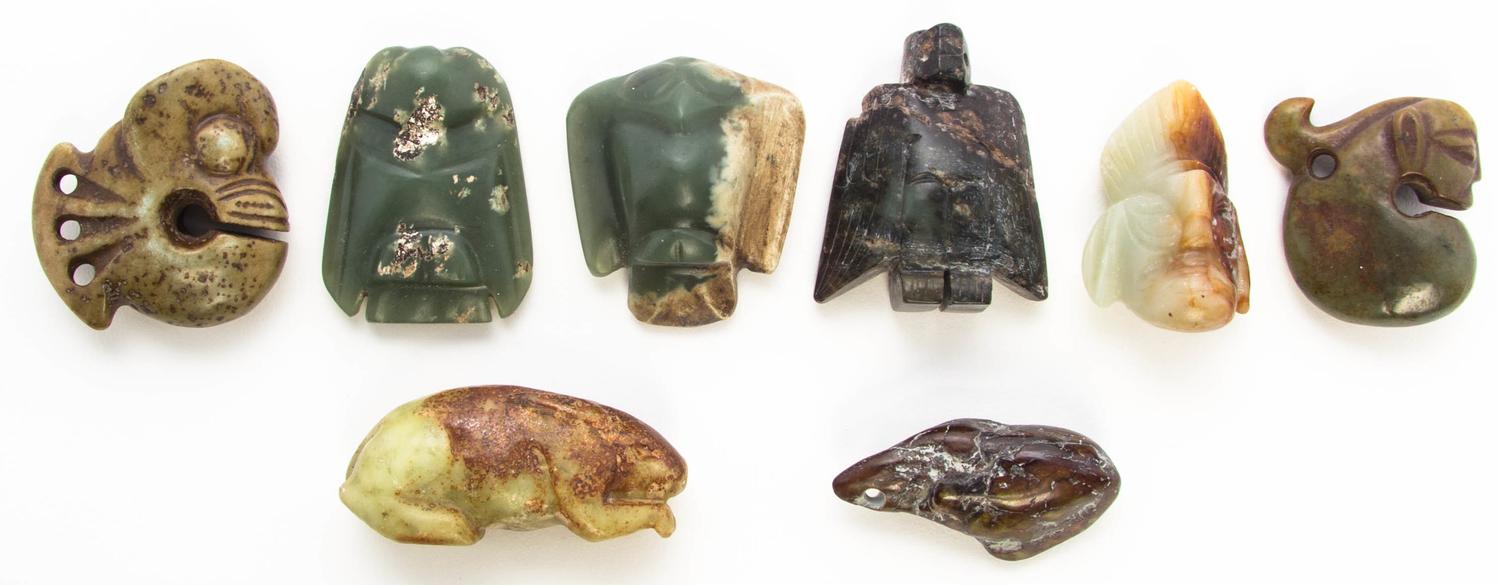 A Group of Eight Carved Hardstone Toggles Length of longest 2 5/8 inches.