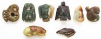 A Group of Eight Carved Hardstone Toggles Length of longest 2 5/8 inches.