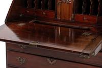 A Chippendale Figured and Shell-Carved Mahogany Slant Front Desk