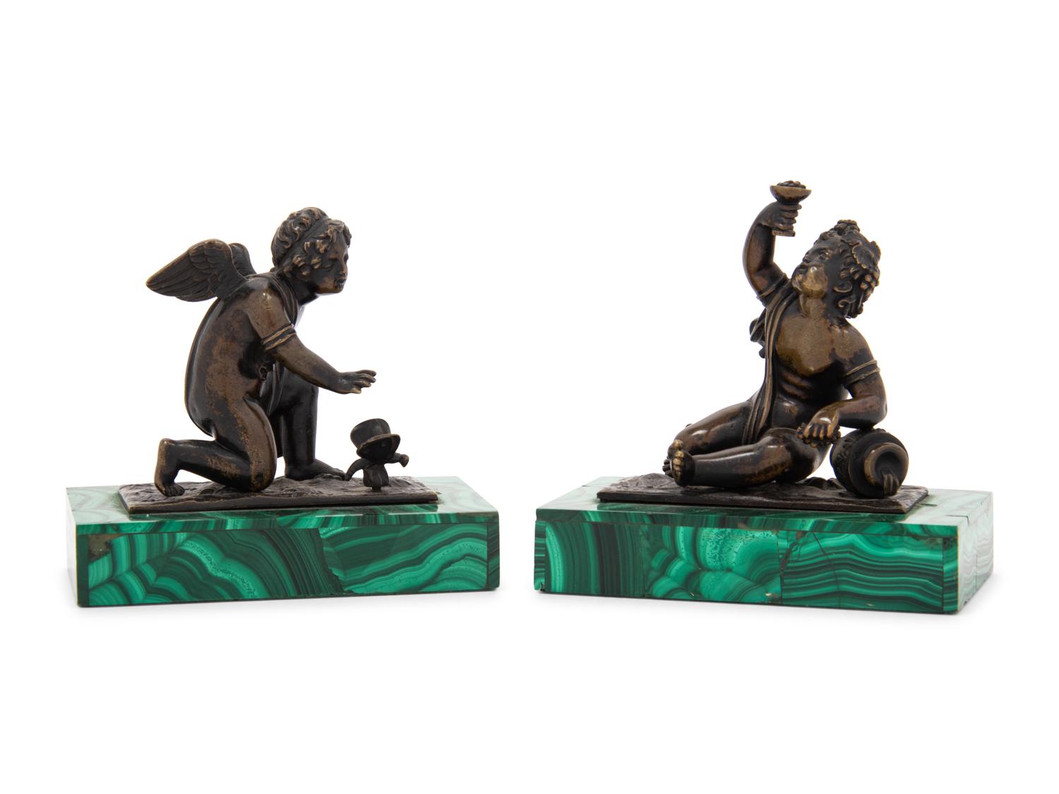 A Pair of Bronze Figures of Kneeling Putti