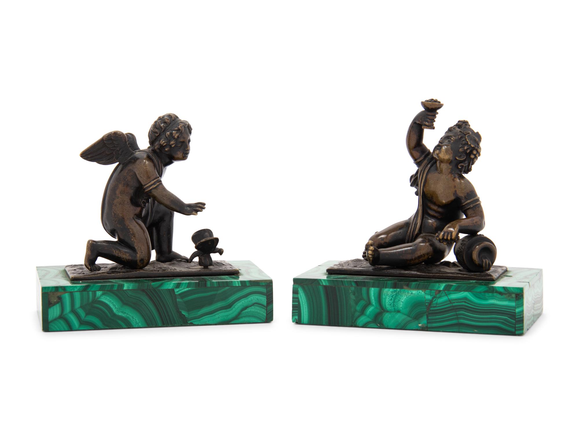 A Pair of Bronze Figures of Kneeling Putti