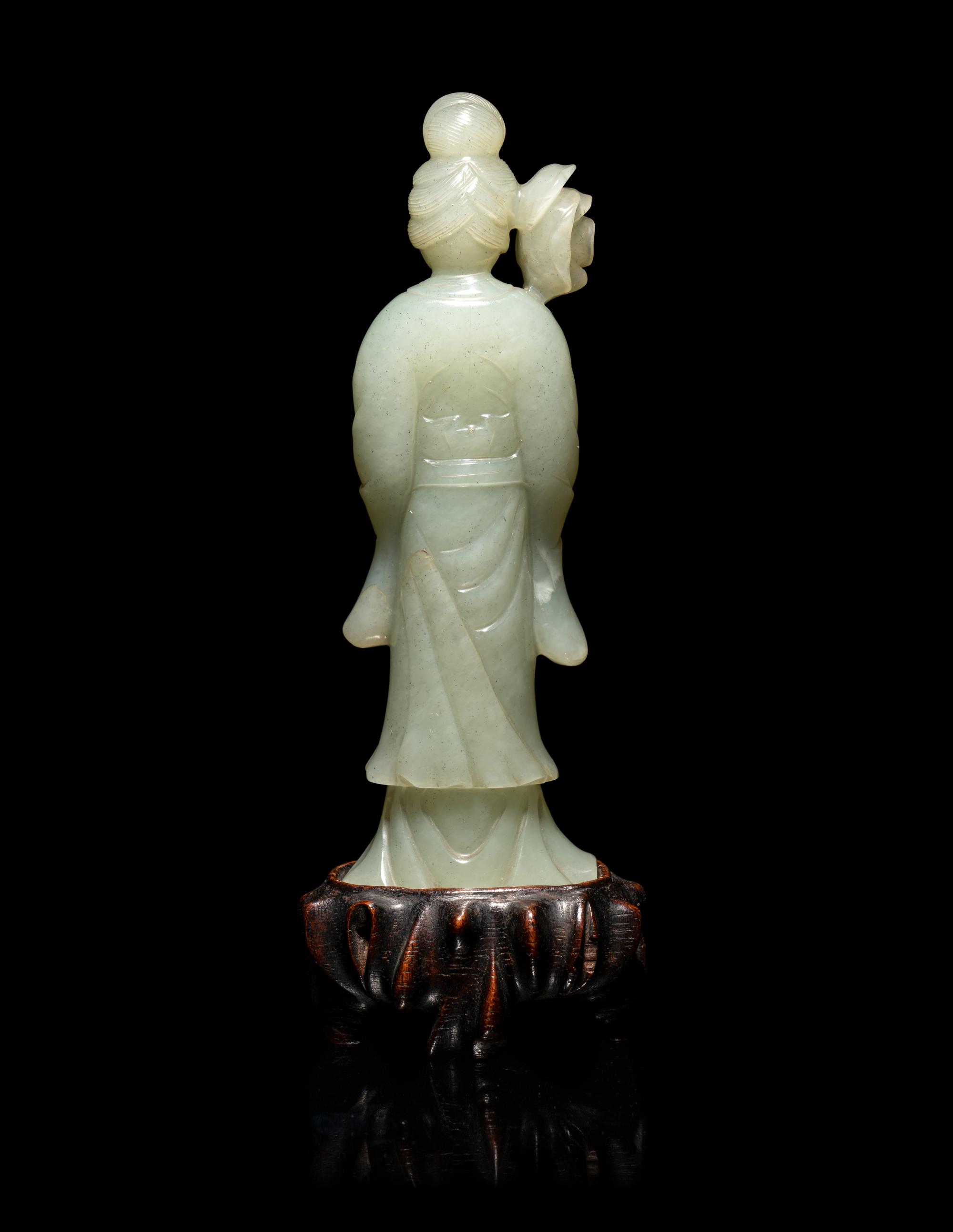 A Chinese Carved Pale Celadon Jade Standing Female Figure
