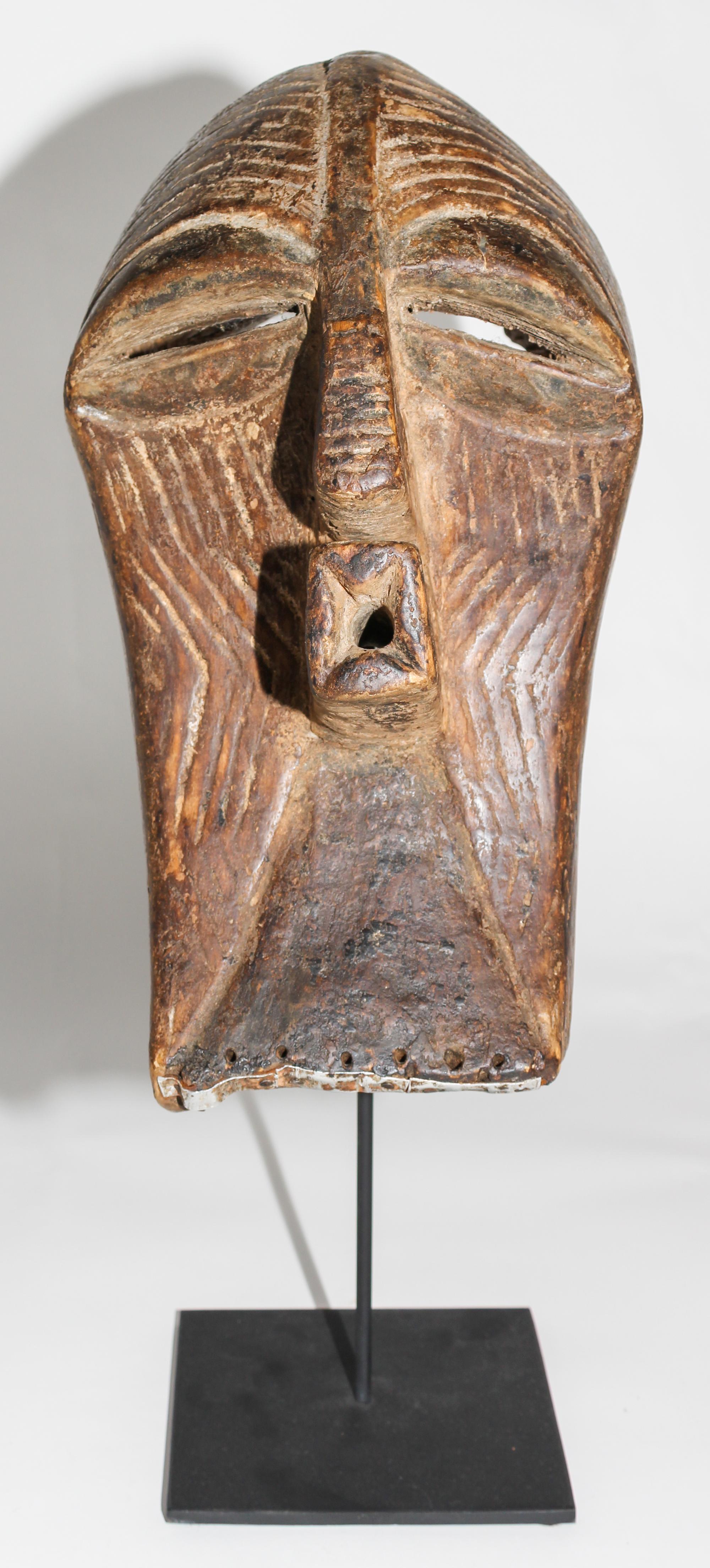 A Songe Wood and Metal Mask. Height 15 inches.