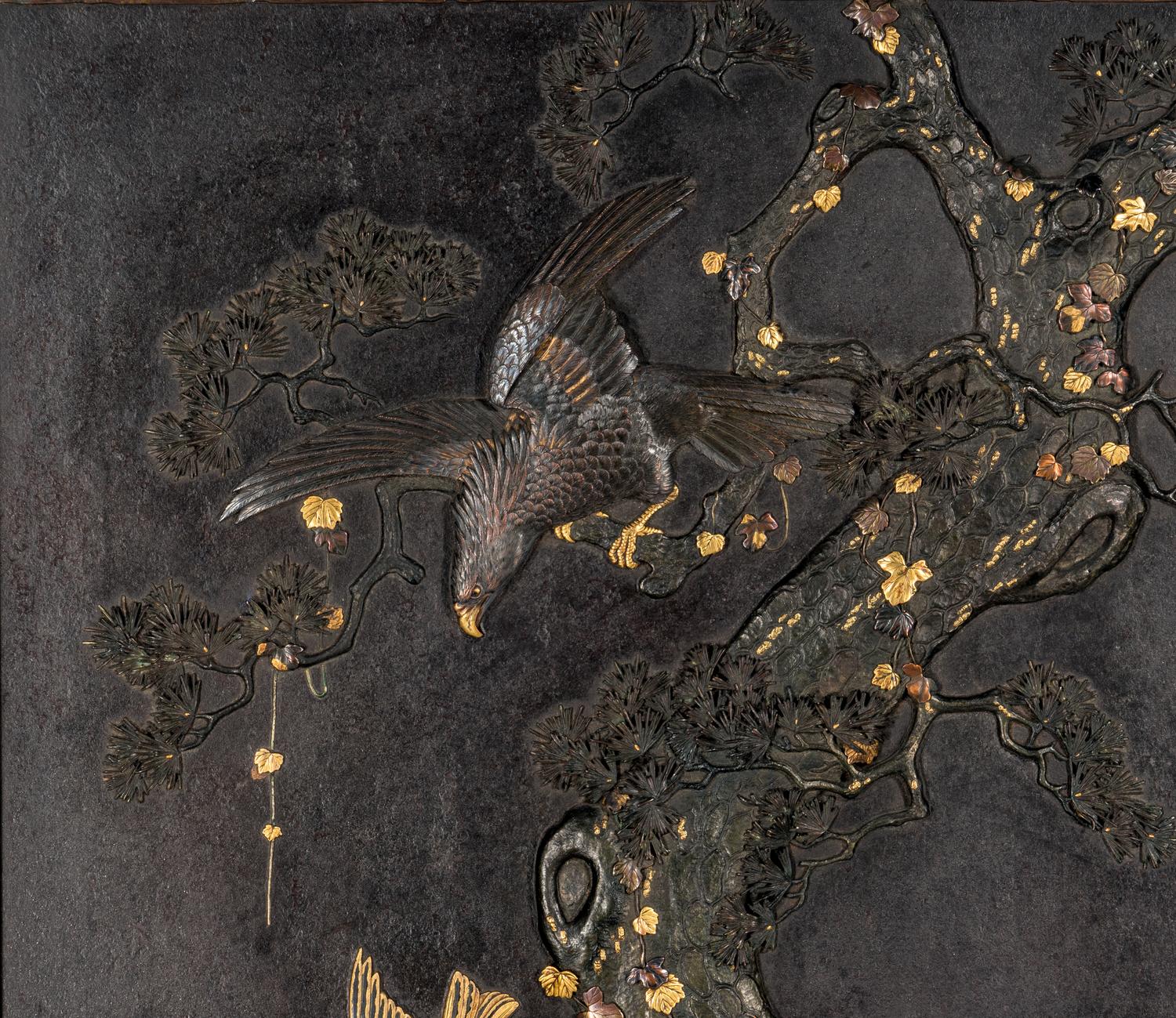 A Japanese Parcel Gilt and Mixed-Metal Inlaid Iron 'Eagle and Pine' Plaque, Meiji Period 日本明治時期 鐵花鳥挂屏