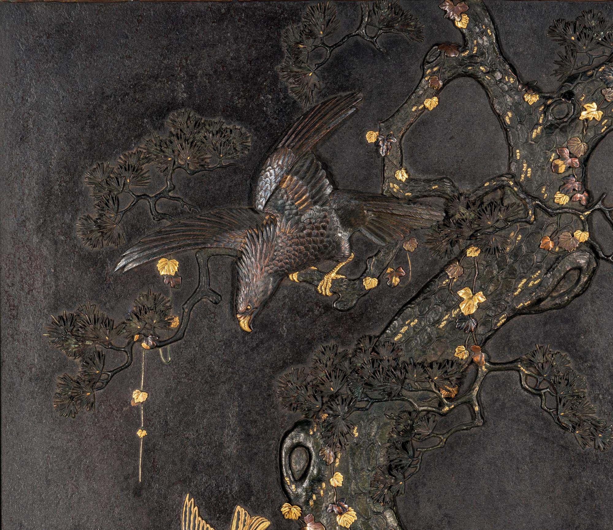 A Japanese Parcel Gilt and Mixed-Metal Inlaid Iron 'Eagle and Pine' Plaque, Meiji Period 日本明治時期 鐵花鳥挂屏