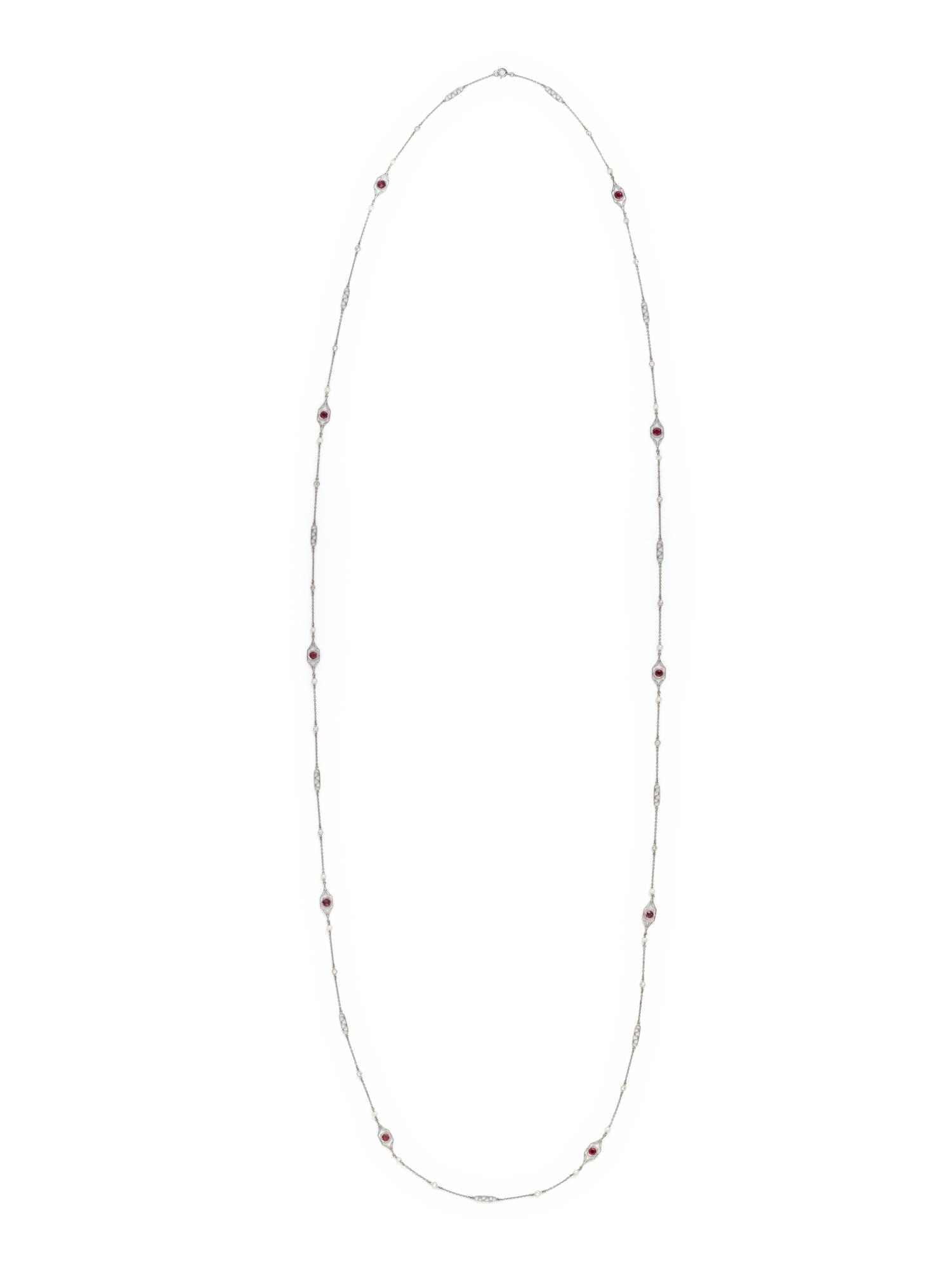 PLATINUM, DIAMOND, SEED PEARL AND SYNTHETIC RUBY LONGCHAIN NECKLACE