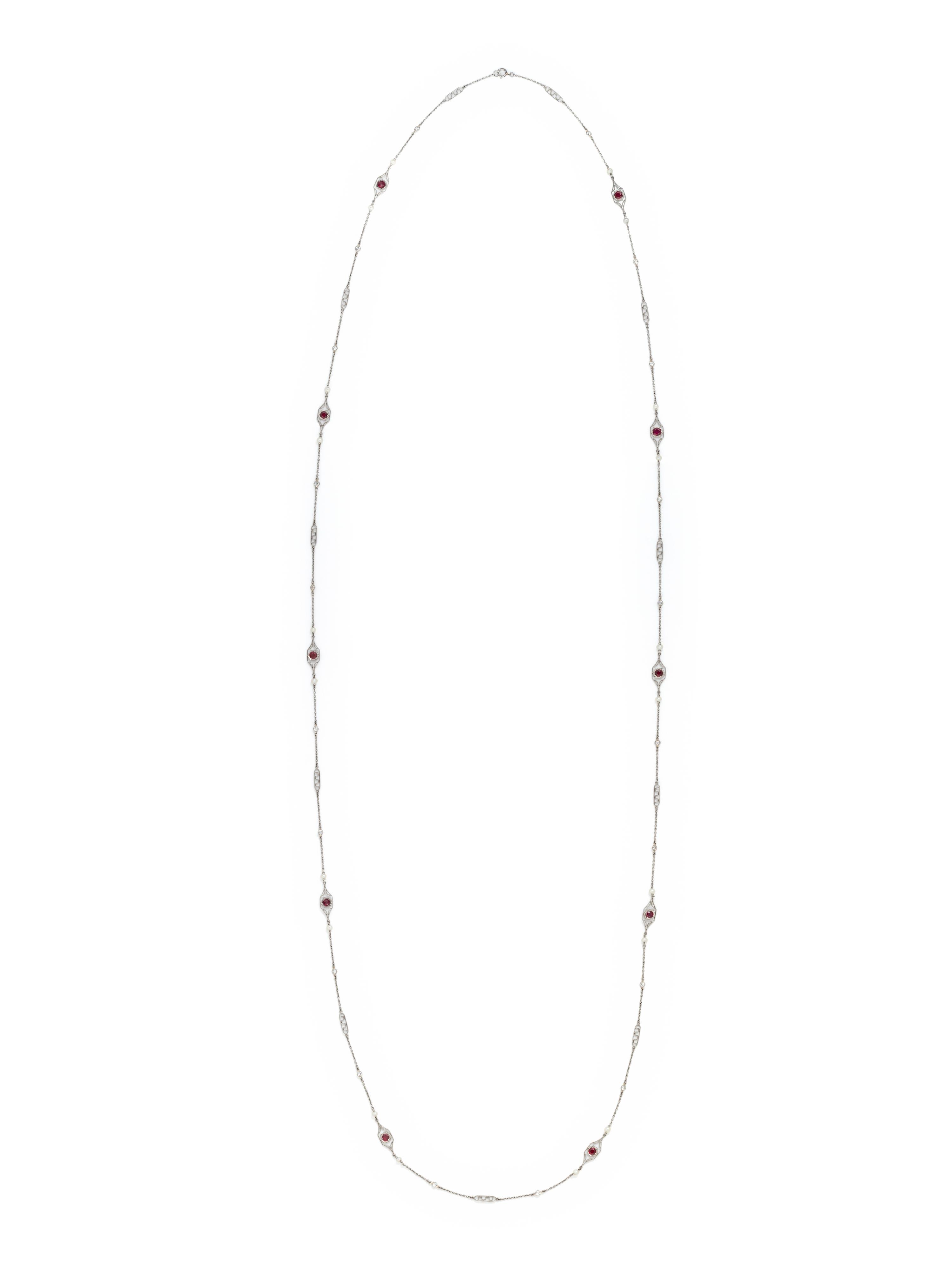 PLATINUM, DIAMOND, SEED PEARL AND SYNTHETIC RUBY LONGCHAIN NECKLACE