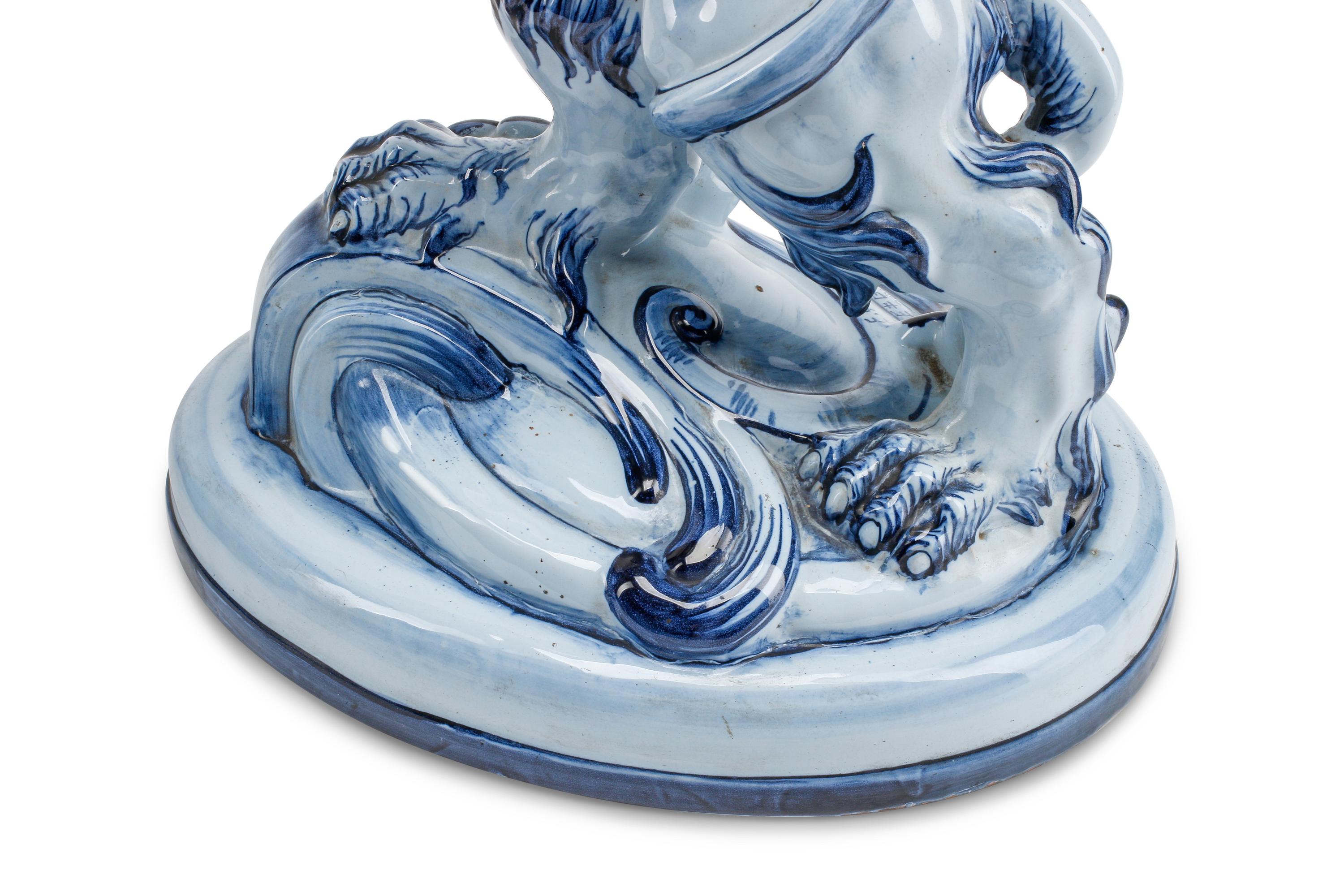 A Pair of French Faience Lion-Form Candlesticks