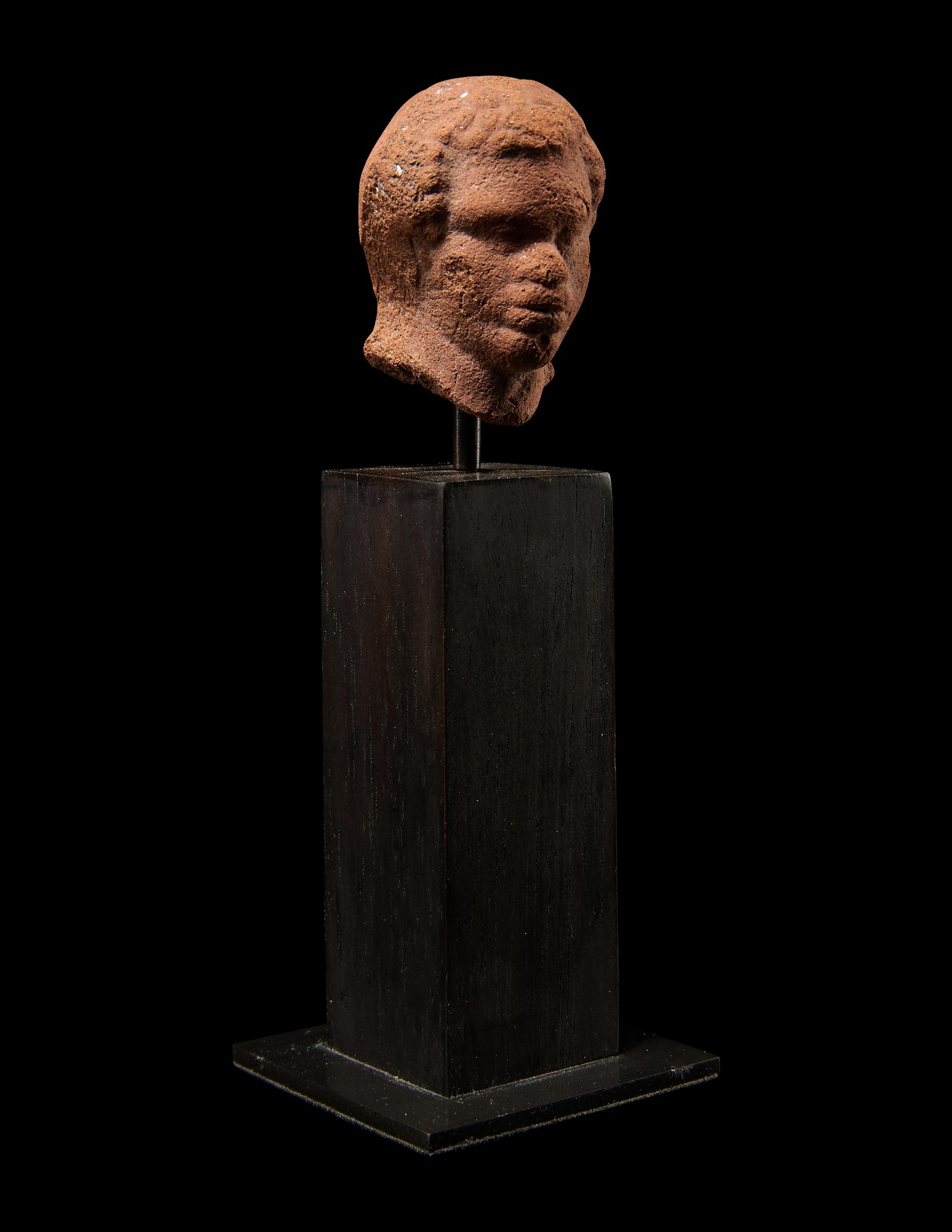 A Nubian Terracotta Head and Reclining Figure