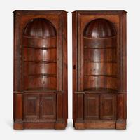 A Pair of George III Style Carved Pine Corner Cabinets late 19th/early 20th century, with later modifications