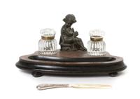 A Continental Cast Metal Figural Encrier, Width of first 14 inches.